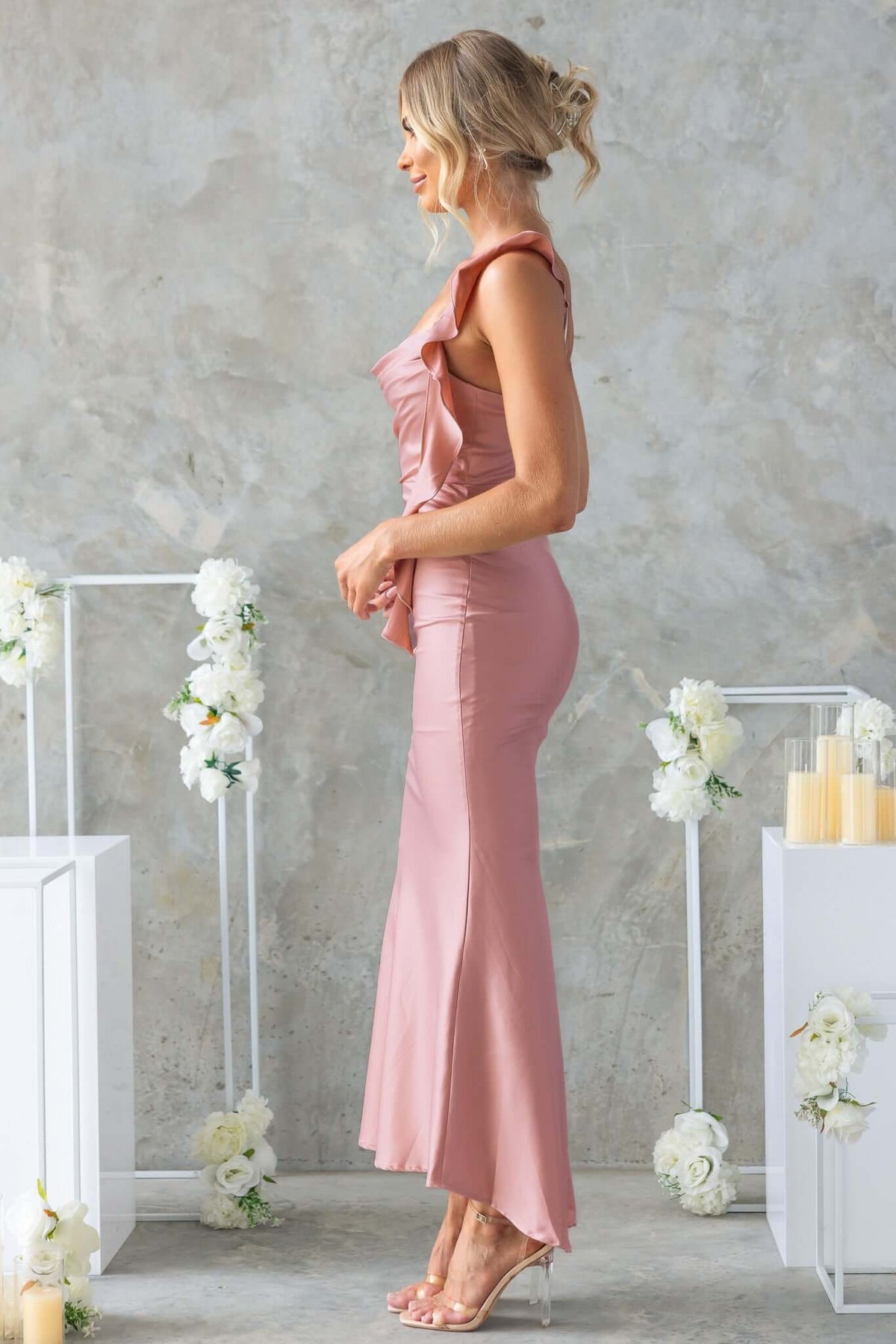 Ingrid Maxi Dress in soft pink, featuring ruffled straps and a flattering fishtail hem, perfect for special occasions.