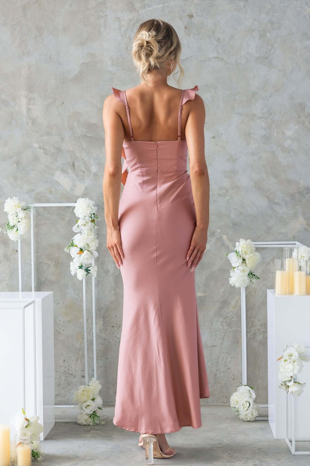 Back view of Ingrid Maxi Dress in soft pink, featuring adjustable straps and a subtle fishtail hem.