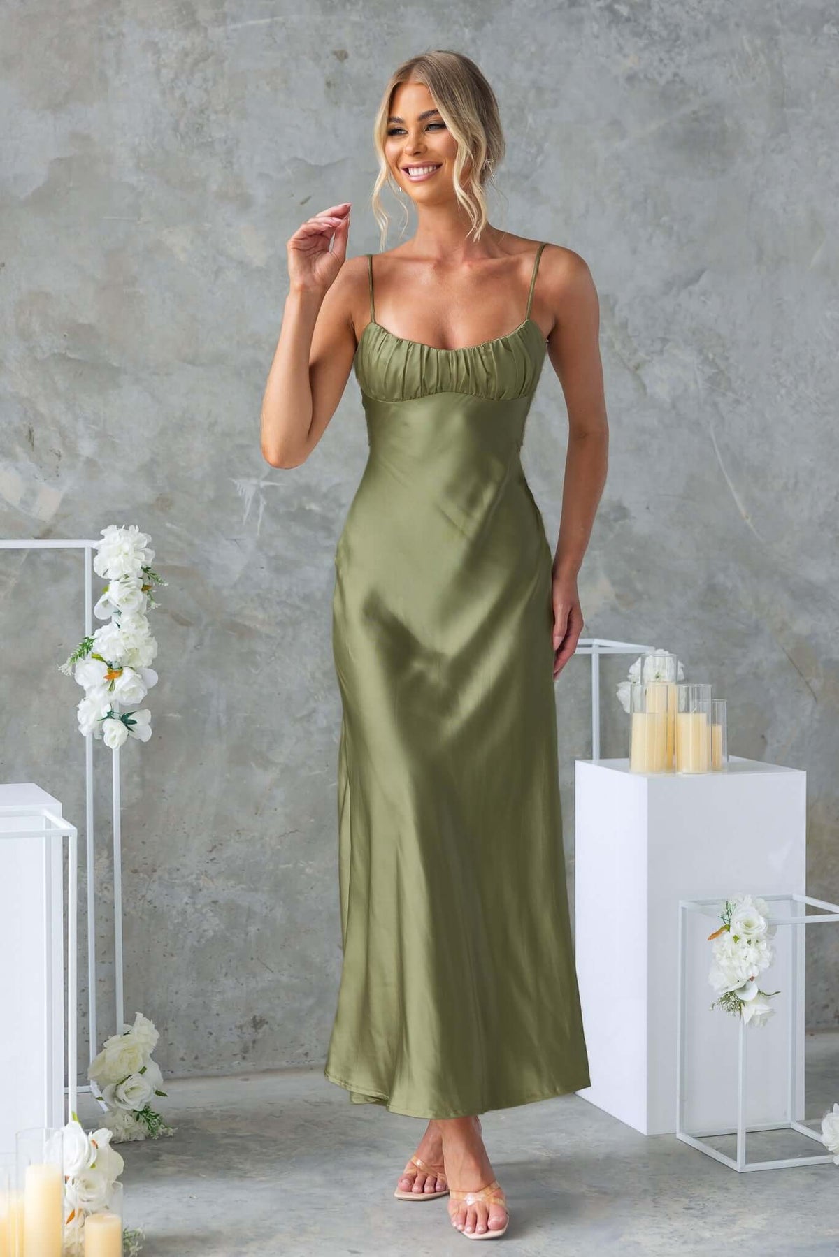 Model wearing a Celine Maxi Dress in olive green, featuring adjustable straps and gathered bust detail.