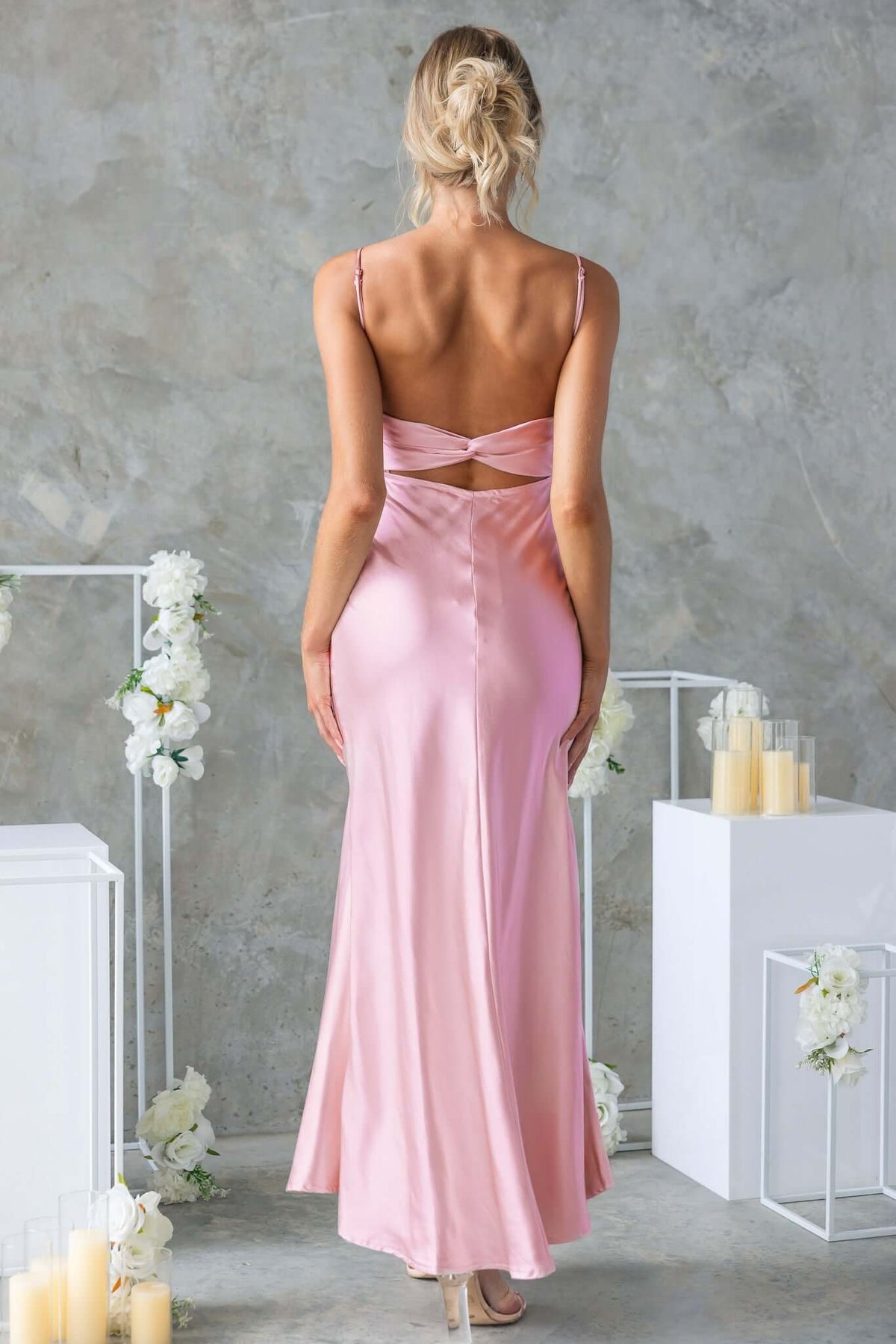 Back view of the Maeya Maxi Dress in blush pink, featuring adjustable straps and cut-out detail.