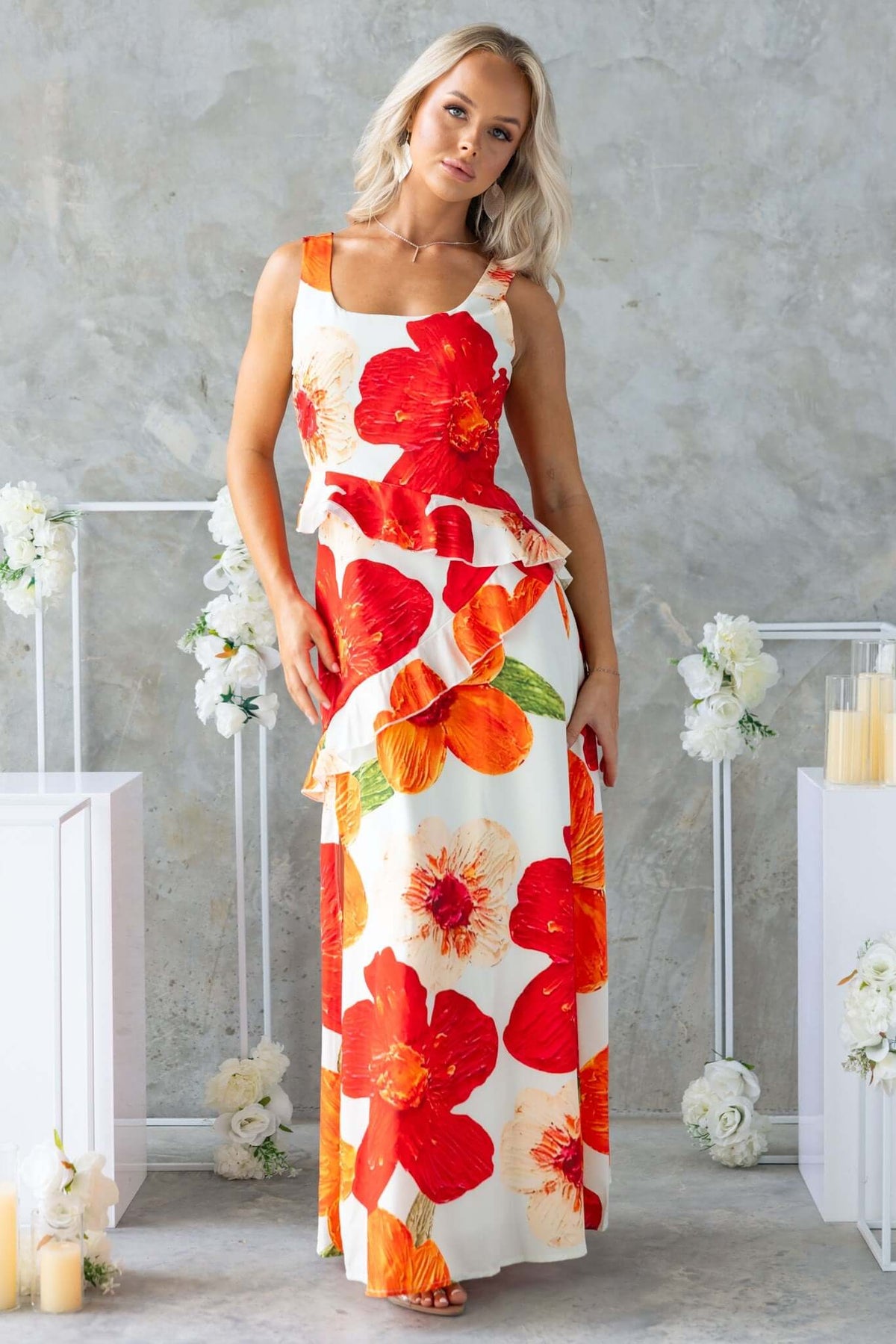 Model wearing a Larni Maxi Dress with vibrant floral print, featuring ruffles and a flattering silhouette.