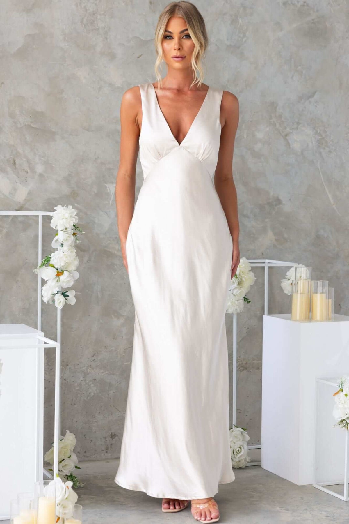 Darina Maxi Dress in satin with V-neckline, elegant bridal wear for special occasions, worn by model against a neutral backdrop.