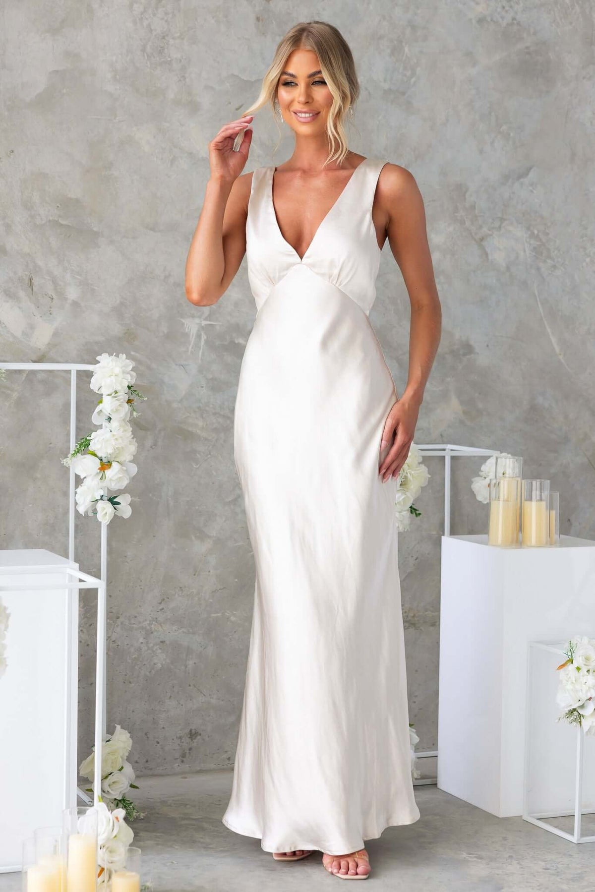 Stylish Darina Maxi Dress in satin with a V-neckline, showcased by a model in a chic setting.