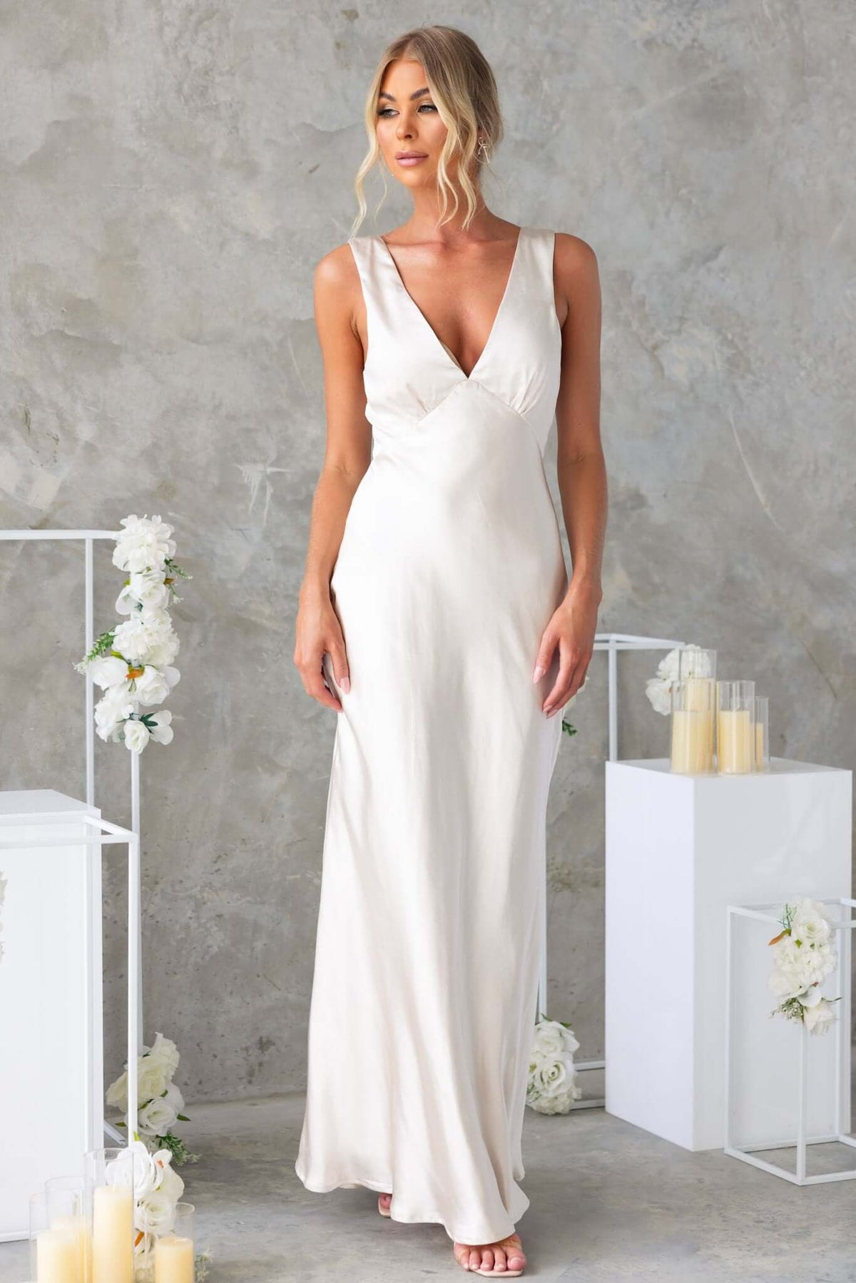 Darina Maxi Dress in satin with V-neckline, model wearing a flowing, lined gown in a neutral shade.