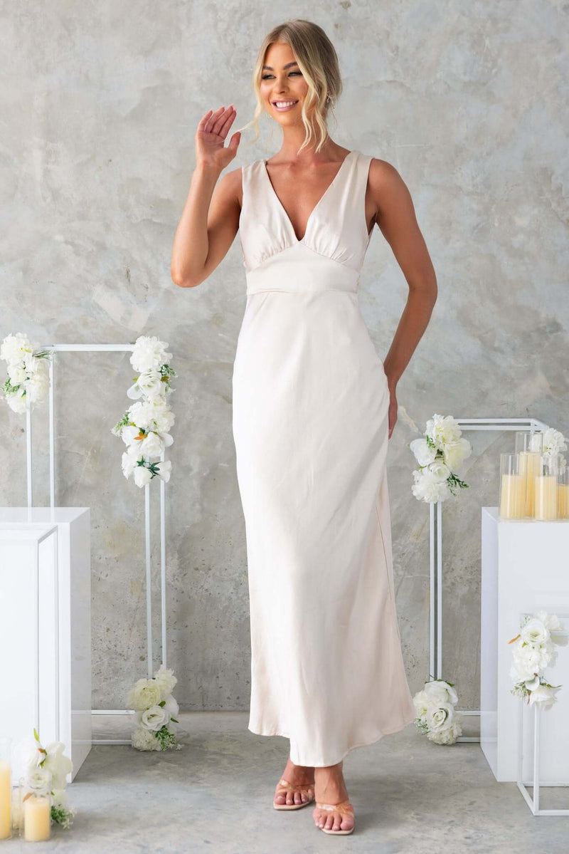 Model wearing Alika Maxi Dress with V-neckline and tied detail, featuring a satin material and a stylish split at the back.