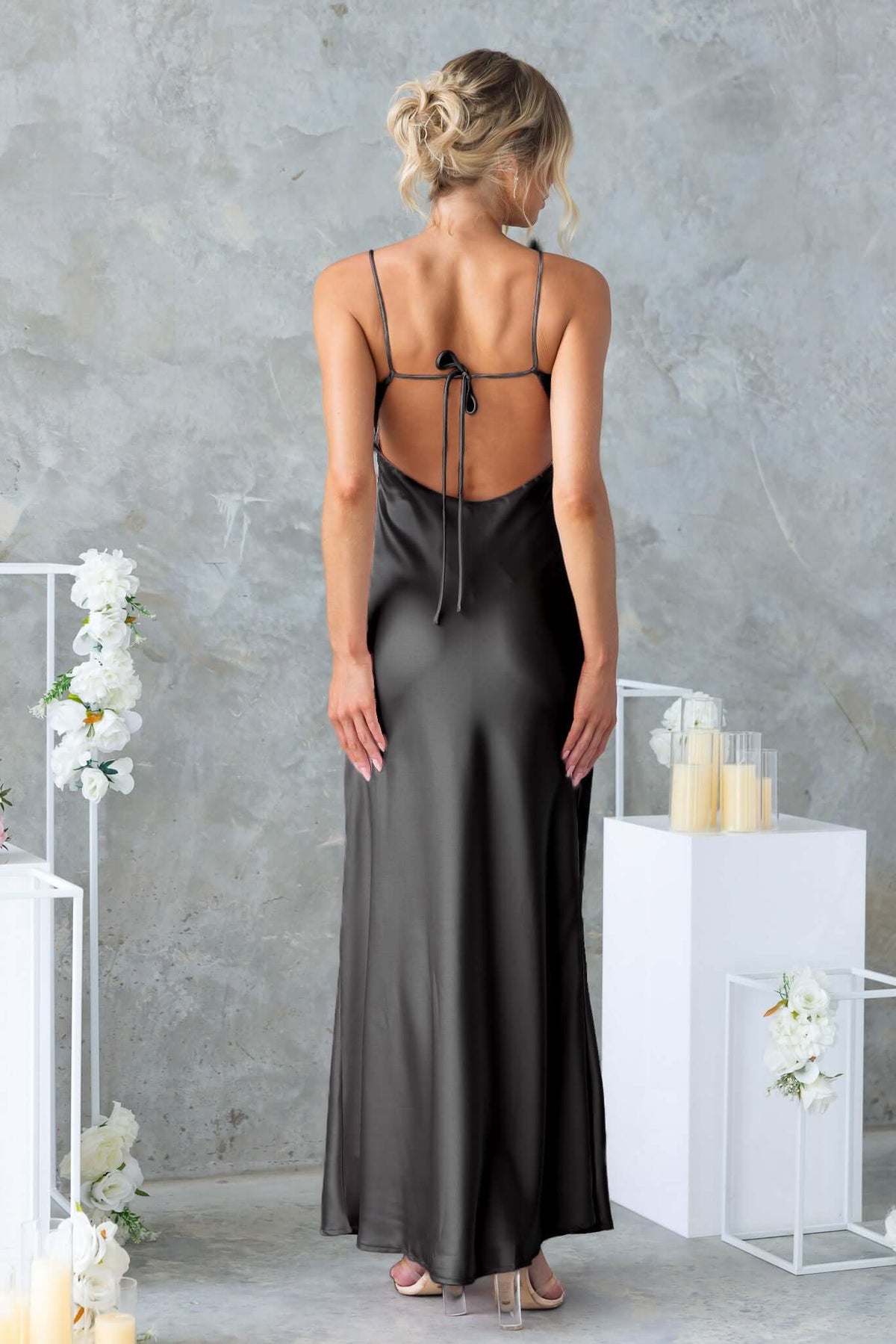 Elegant black satin Hasina Maxi Dress showcasing adjustable straps and a stylish back tie design.