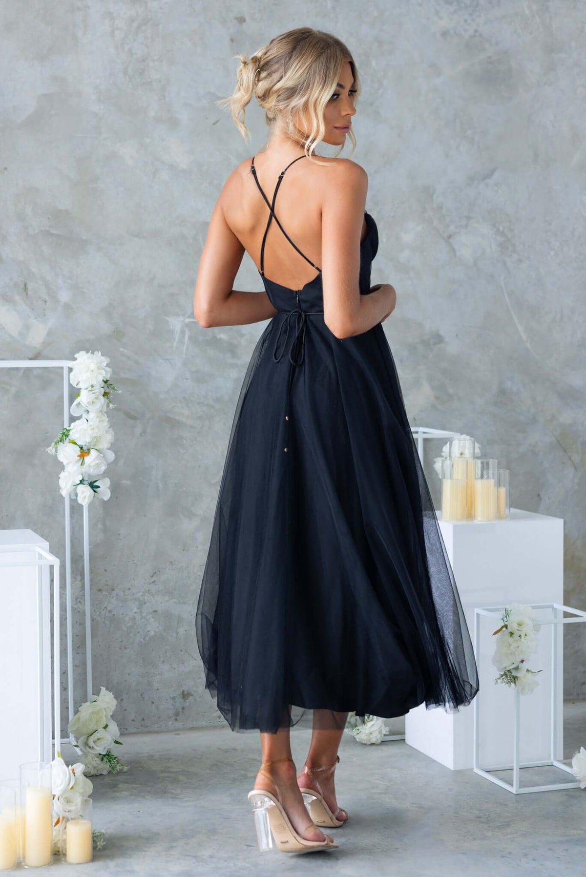 Back view of the Florence Midi Dress in black with cross-over straps and tulle material, showcasing a chic bridal look.
