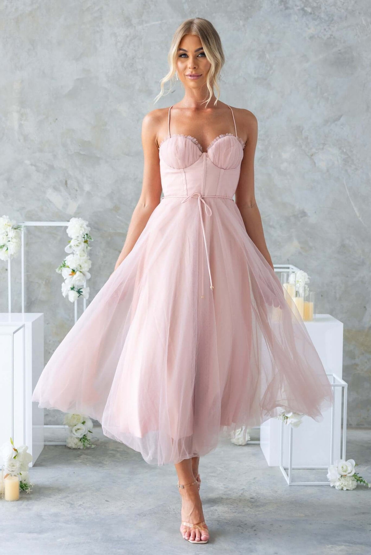Florence Midi Dress in soft pink tulle, featuring adjustable straps, padded bust, and a removable fabric tie.