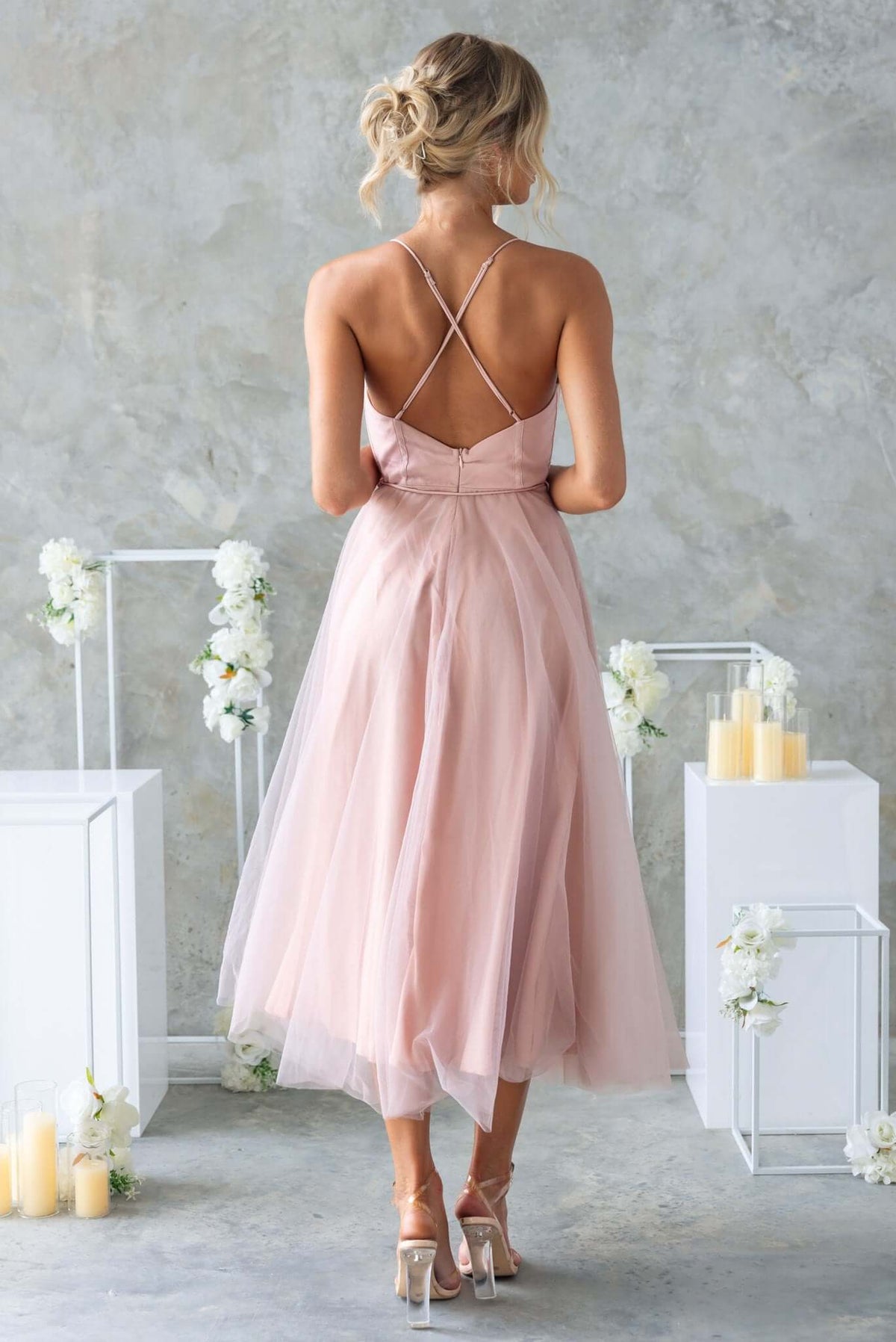 Back view of Florence Midi Dress featuring adjustable cross-over straps and a flowing tulle skirt in soft pink.