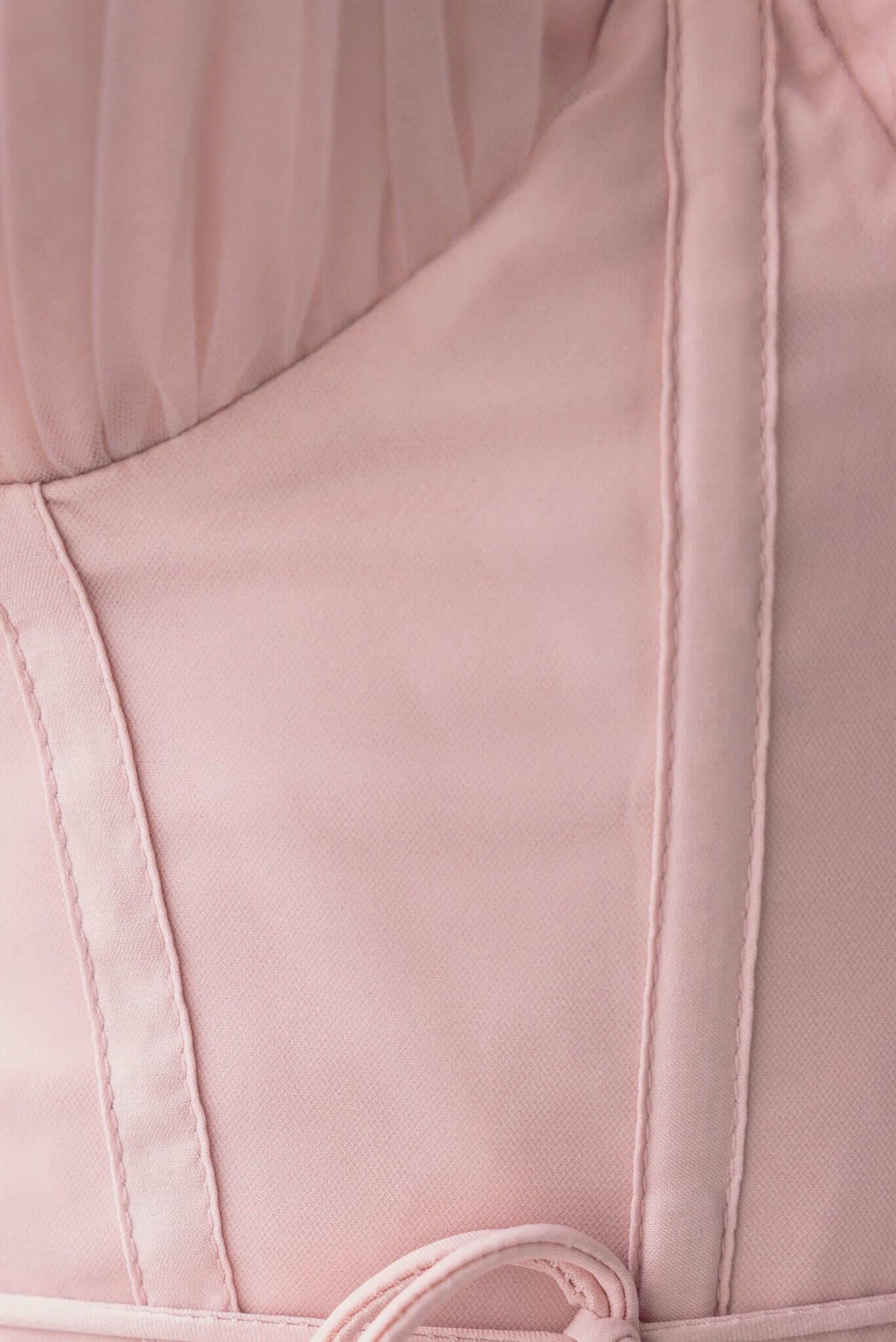 Close-up of the Florence Midi Dress, showcasing delicate pink fabric, boning details, and adjustable tie.