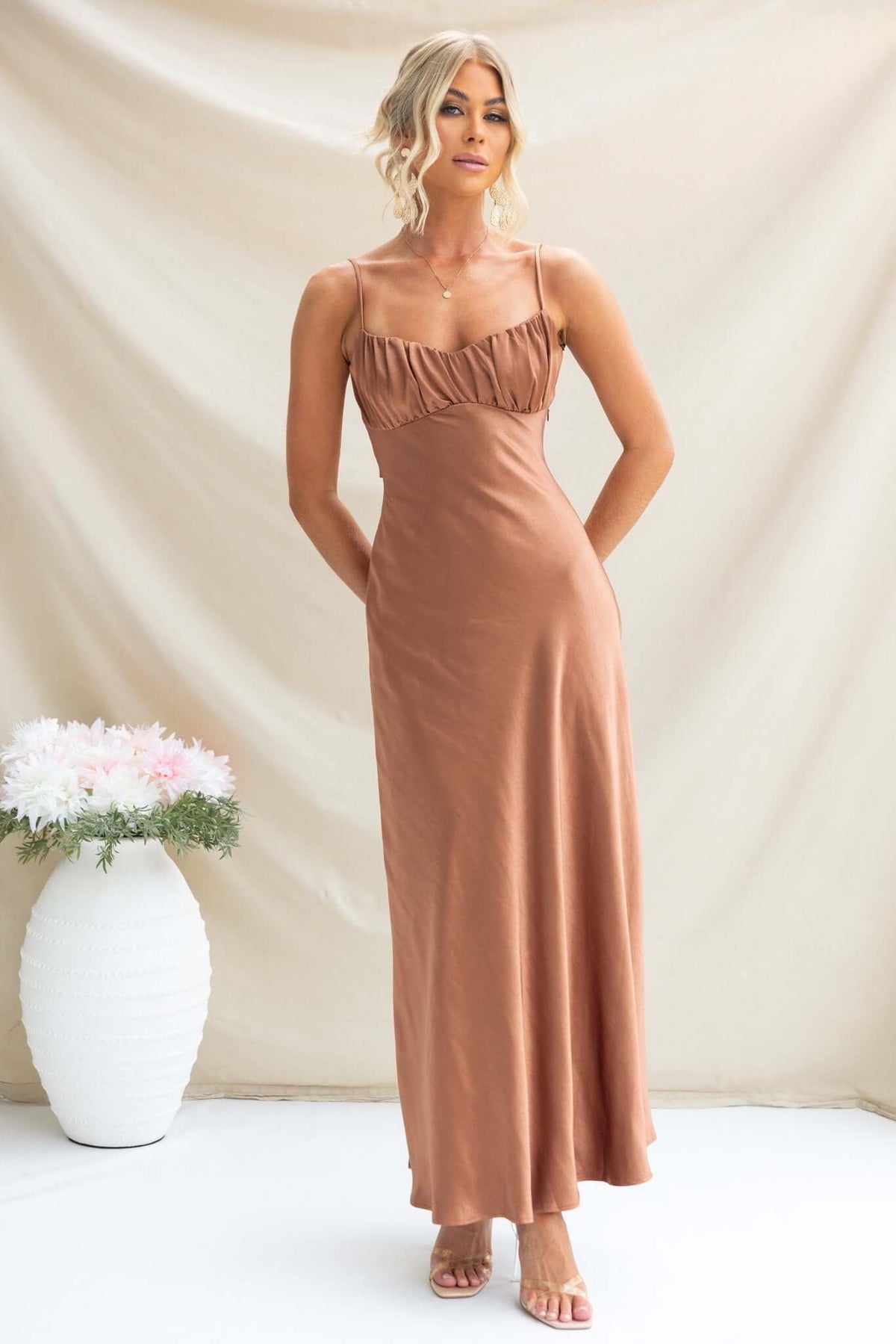 Model wearing Maeya Maxi Dress featuring adjustable straps and gathered bust in satin material.