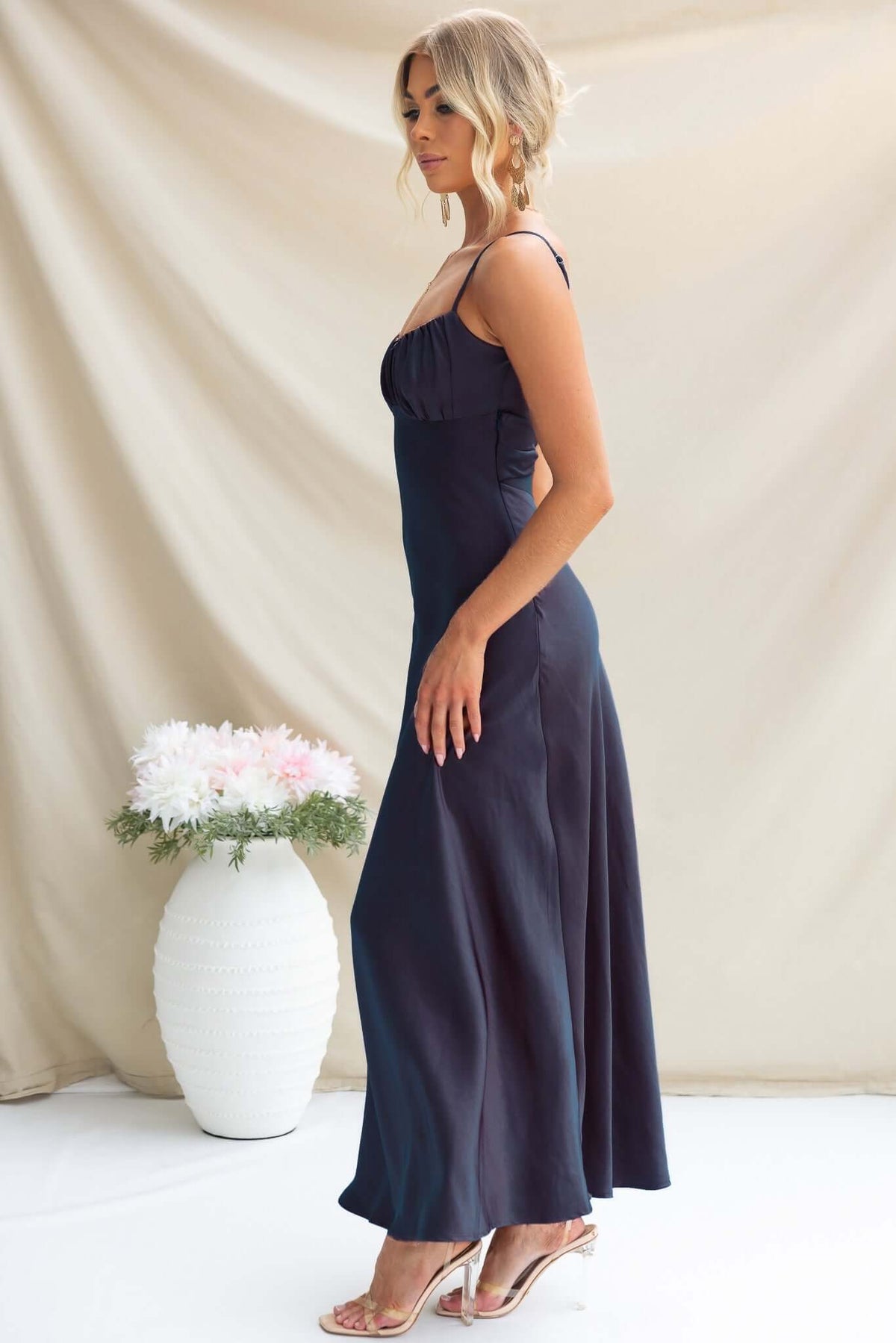 Maeya Maxi Dress in Navy with adjustable straps and cut-out back, displayed on model against a soft backdrop.
