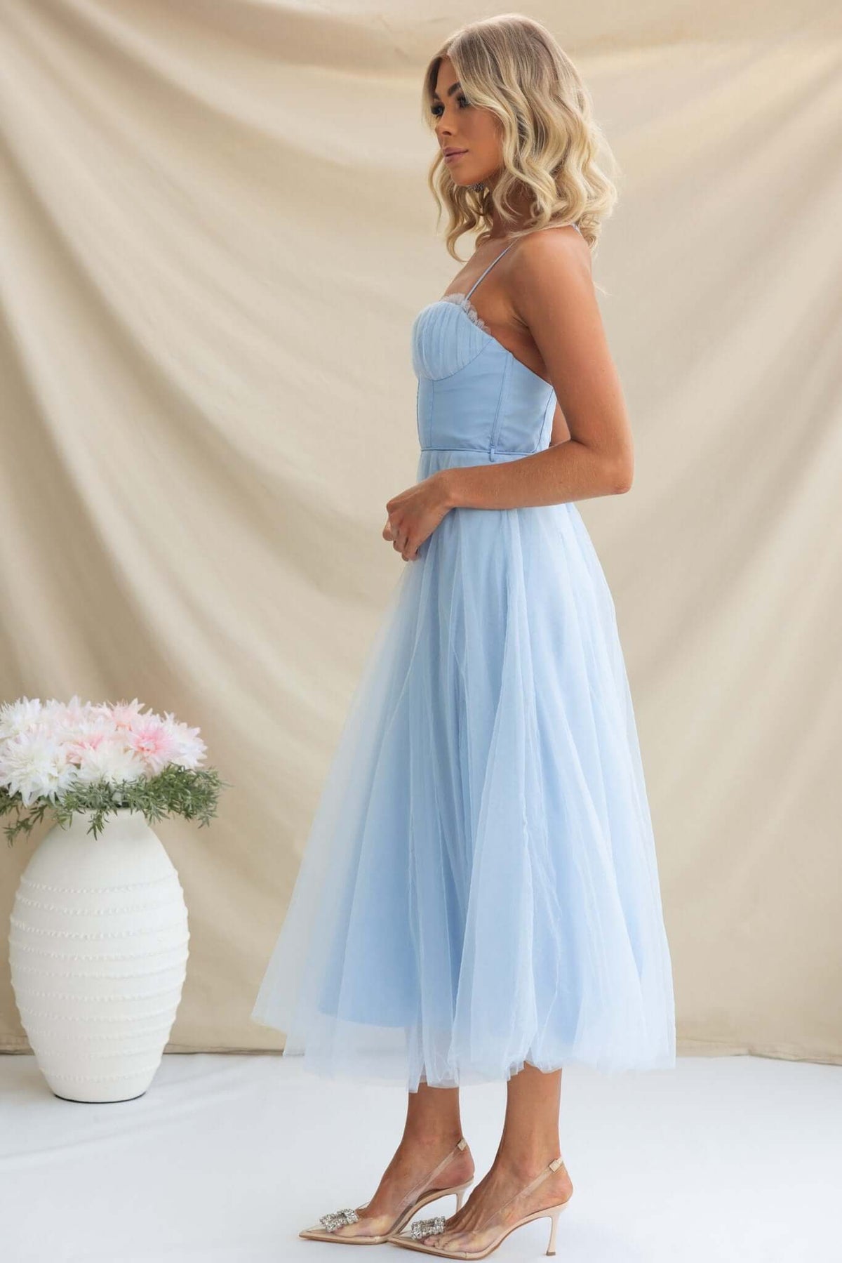 Model wearing the Florence Midi Dress in light blue, featuring adjustable straps and a voluminous tulle skirt.