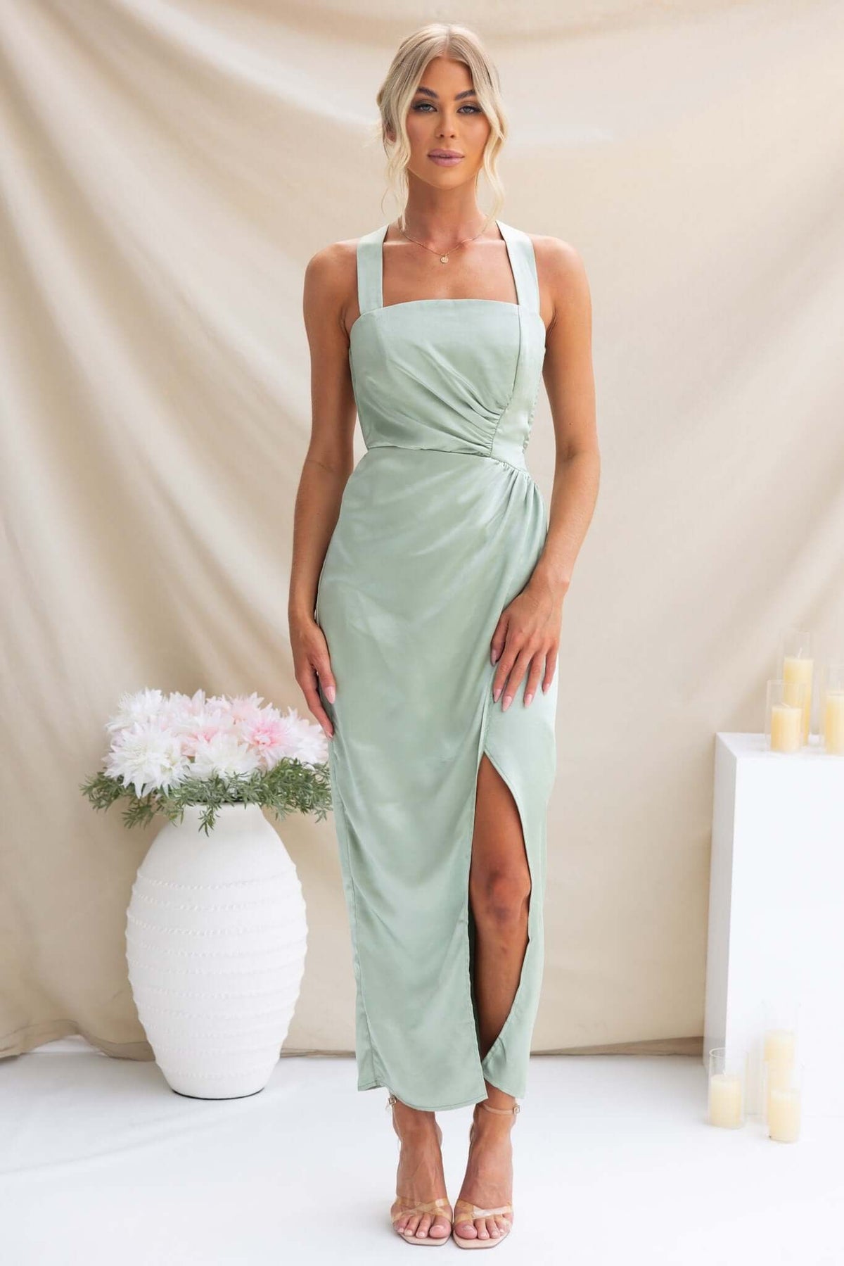 Elegant Merritt Maxi Dress in soft green with tie straps and side slit, perfect for weddings or special occasions.