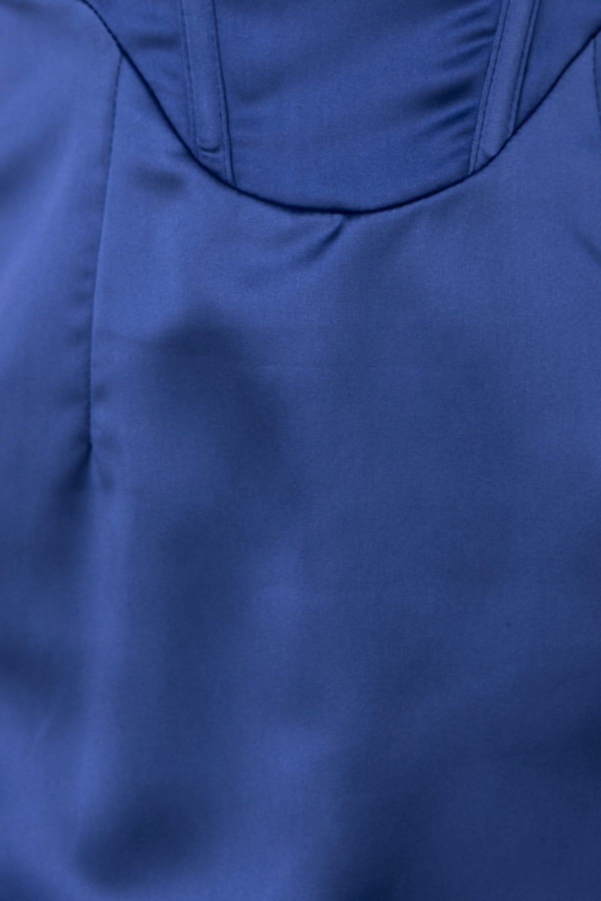 Close-up of the bold steps dress showcasing its satin texture and padded bust design.