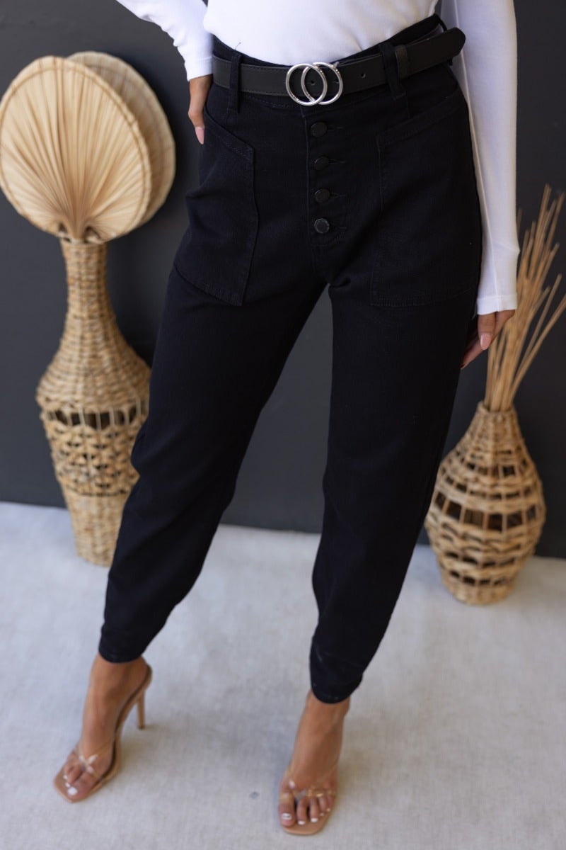 Watson Jeans in black denim with mid-high waist, button-up front, and pockets. Stylish firm stretch fit for any occasion.