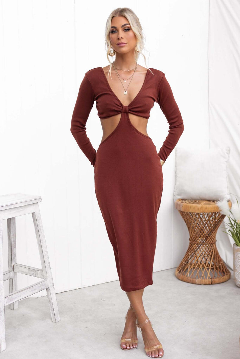 Kartier Midi Dress in rust with V-neckline, cut-out waist, and side split, worn by model in a stylish setting.