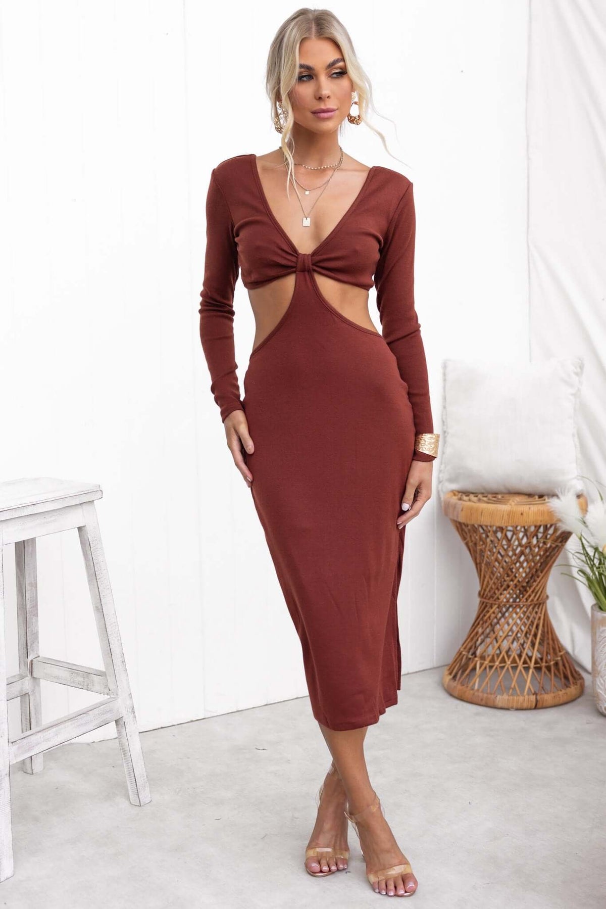 Model wearing a Kartier Midi Dress in brown, featuring a V-neckline, cut-out at waist, and side split.
