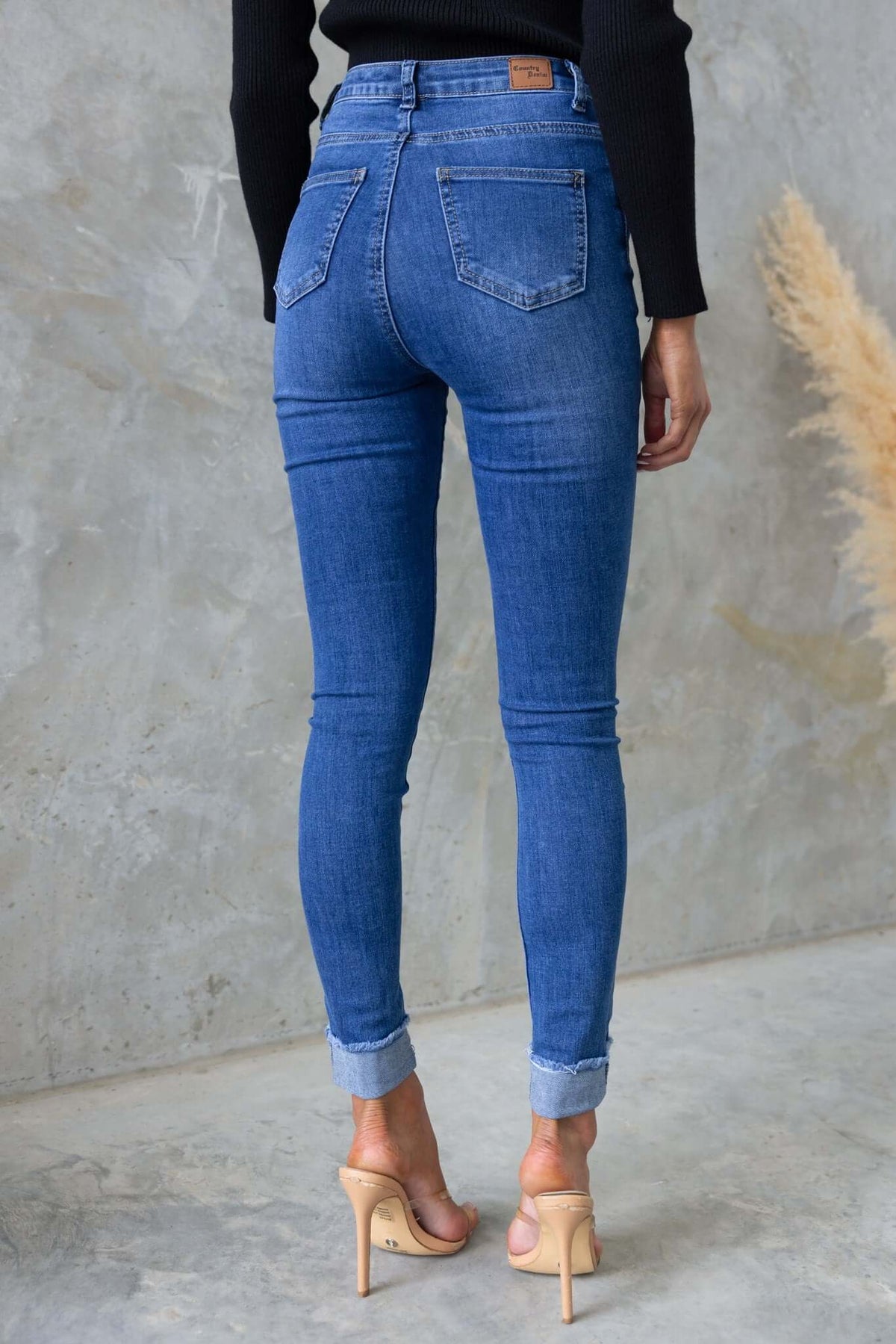 Lettie Jeans back view: mid-high waist, distressed denim, stretch material, front and back pockets.