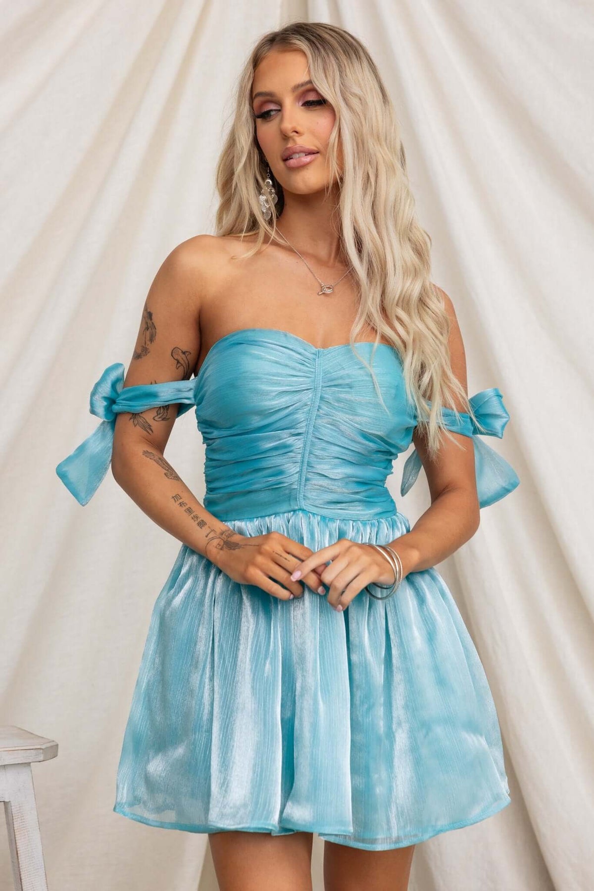 Irena Dress in teal with adjustable tie straps, padded bust, and flared tulle underskirt.