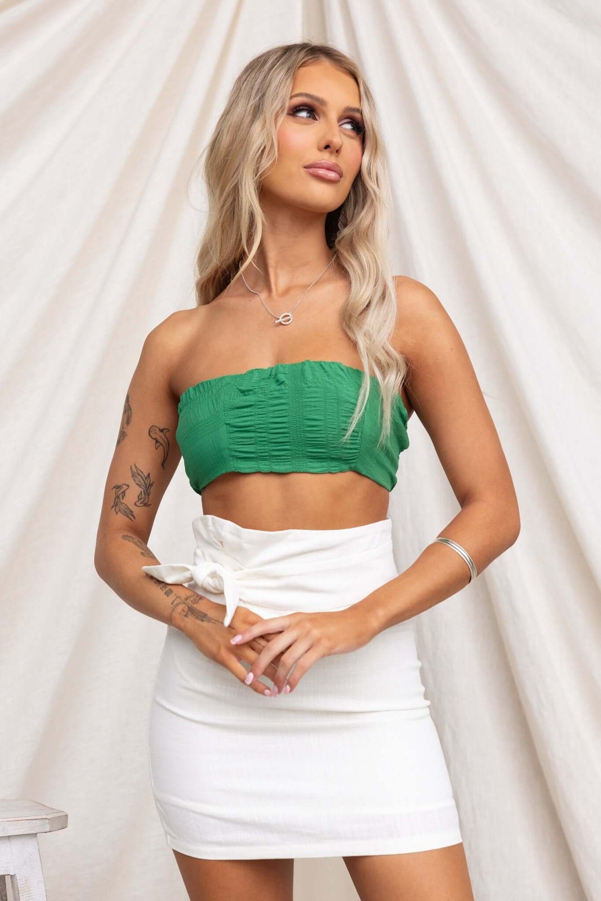 Omalie Top in green, featuring textured material and anti-slip design, styled with a white skirt.