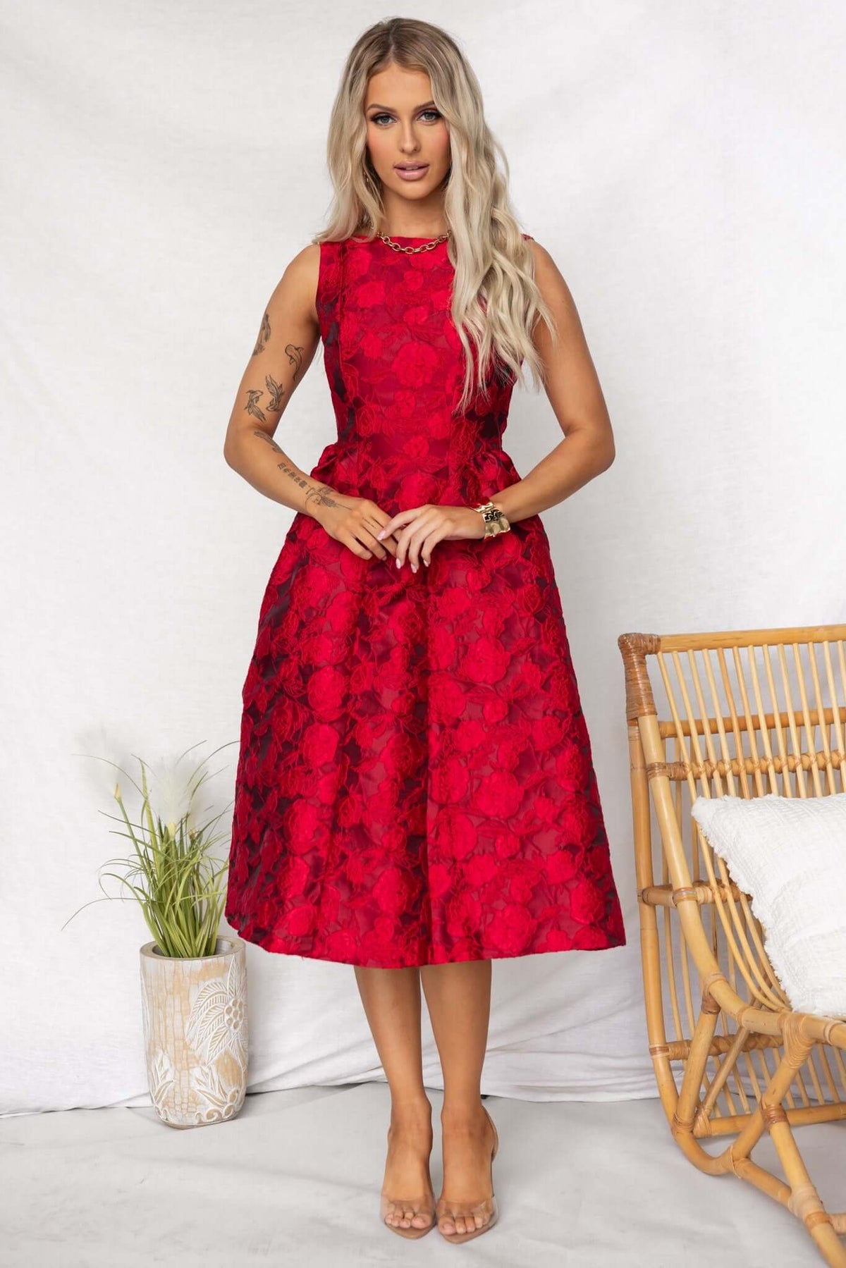 Jadyne Midi Dress in vibrant red floral texture, featuring a sleeveless design and knee-length cut, styled for a chic look.