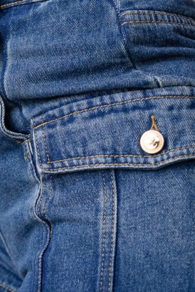 Close-up of Osment denim shorts showcasing the mid-high waist fit and button detail.