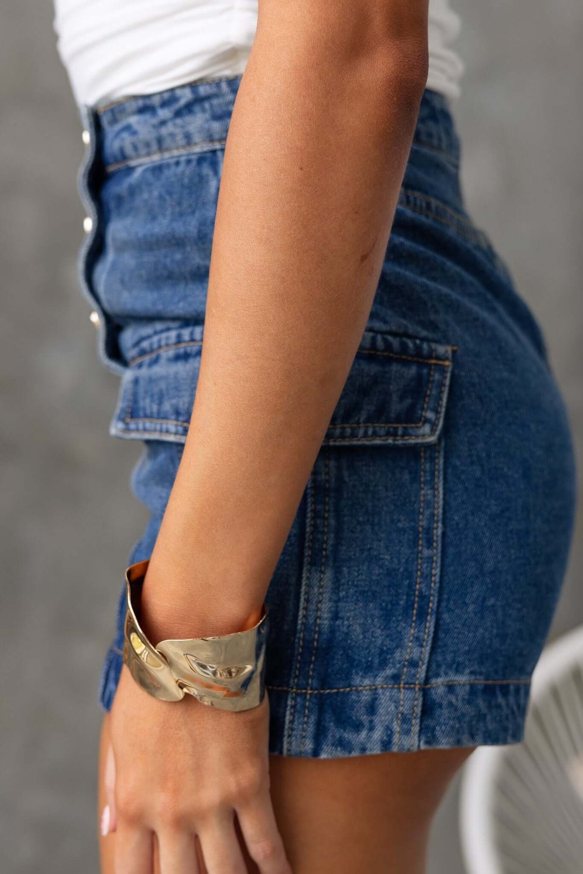 Side view of Osment Denim Shorts featuring mid-high waist, button-up front, and side pockets.