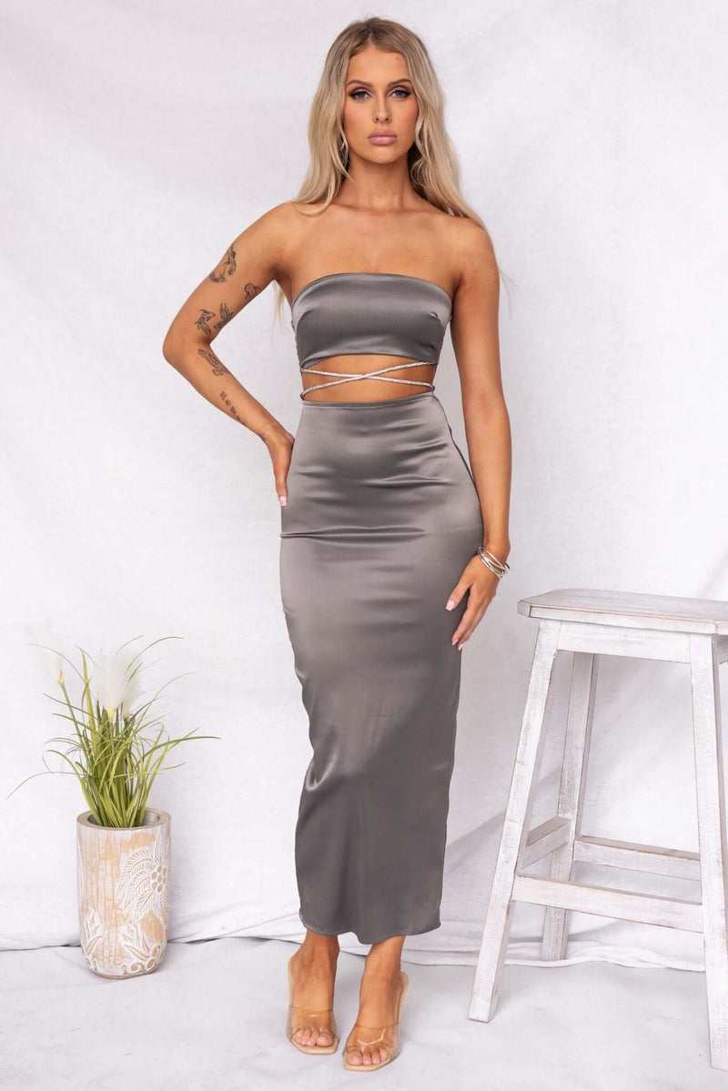 Satin Louise Maxi Dress in grey, strapless with cut-out details, back split, and adjustable tie for a flattering fit.