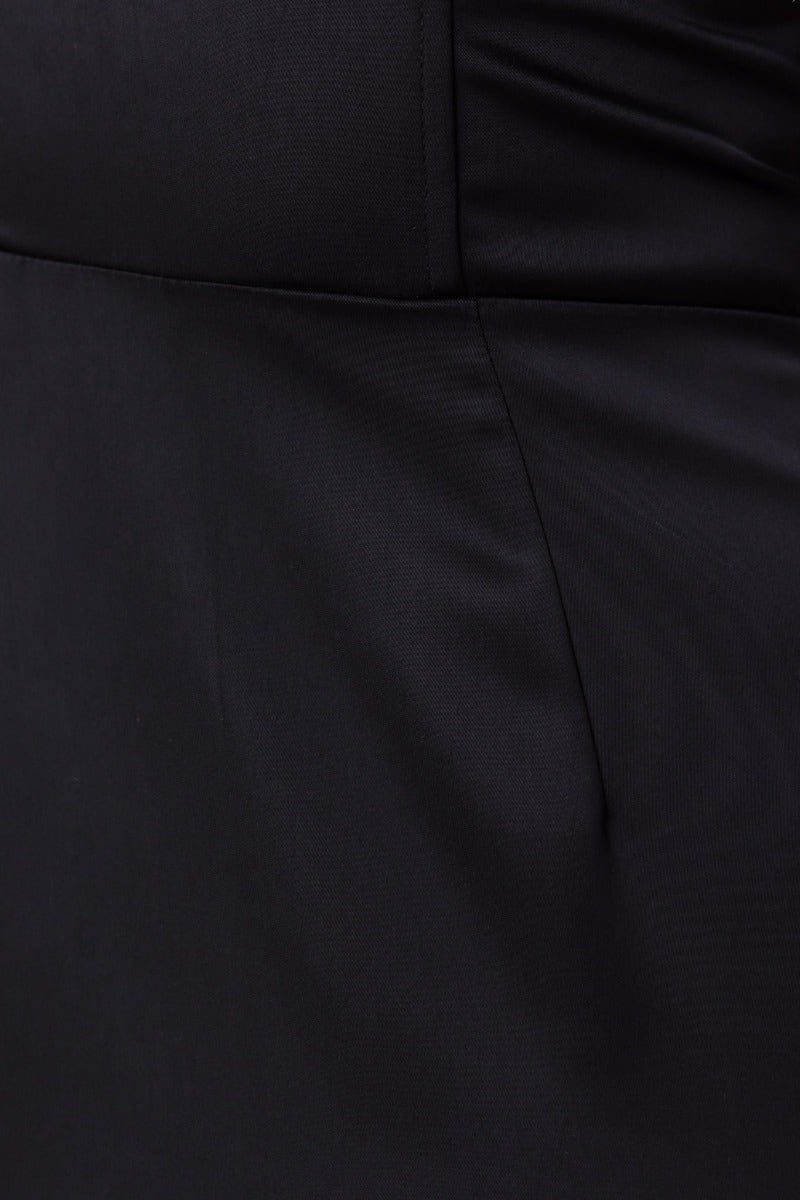Close-up of black satin fabric on Azora maxi dress, featuring smooth texture and elegant design.