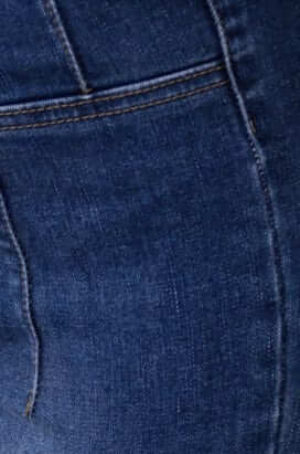 Close-up of Okara Jeans featuring mid-high waist fit and firm stretch denim fabric.