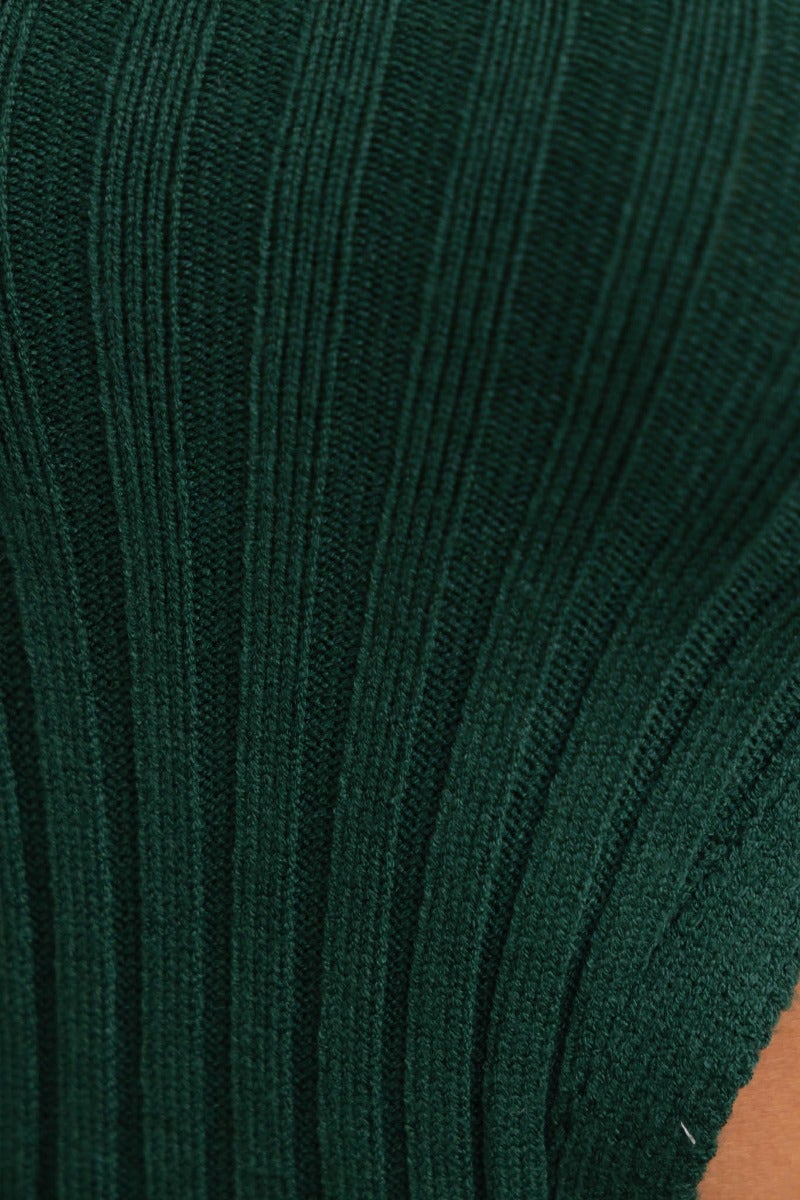 Close-up of green ribbed knit fabric from the Stassie Midi Dress, showcasing its textural detail and quality.