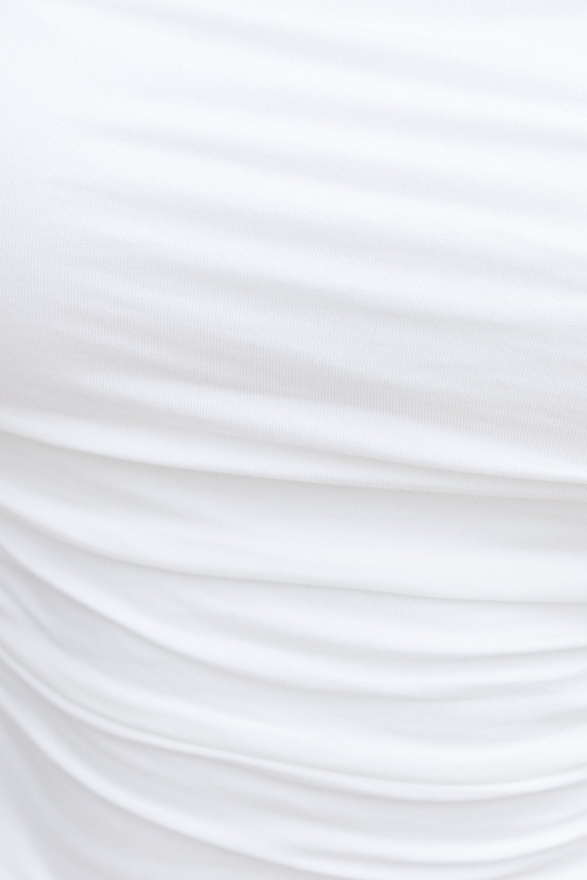 Close-up of soft, white, stretchy fabric with gathered design, perfect for Pippie Top.