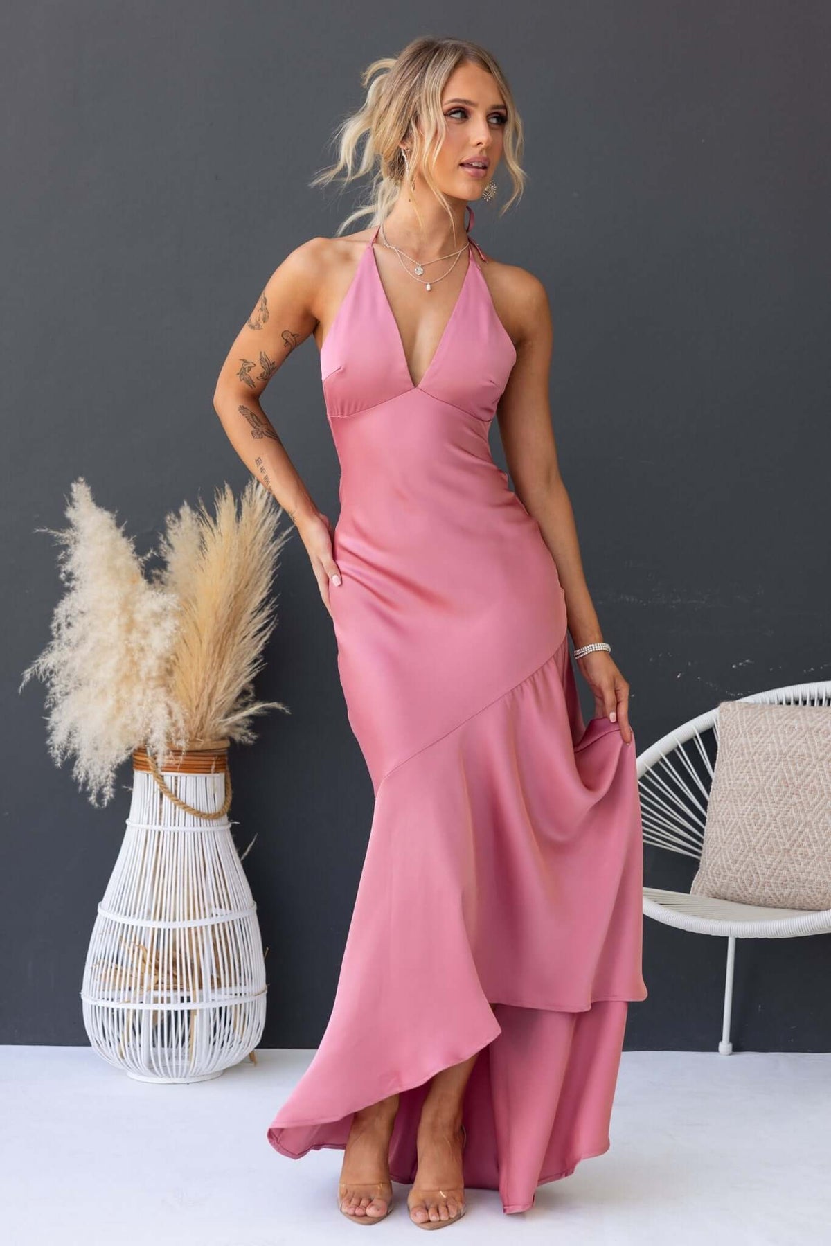 Model wearing a pink Ramona Maxi Dress with a tie neckline, showcasing a flowy skirt and elegant fit.