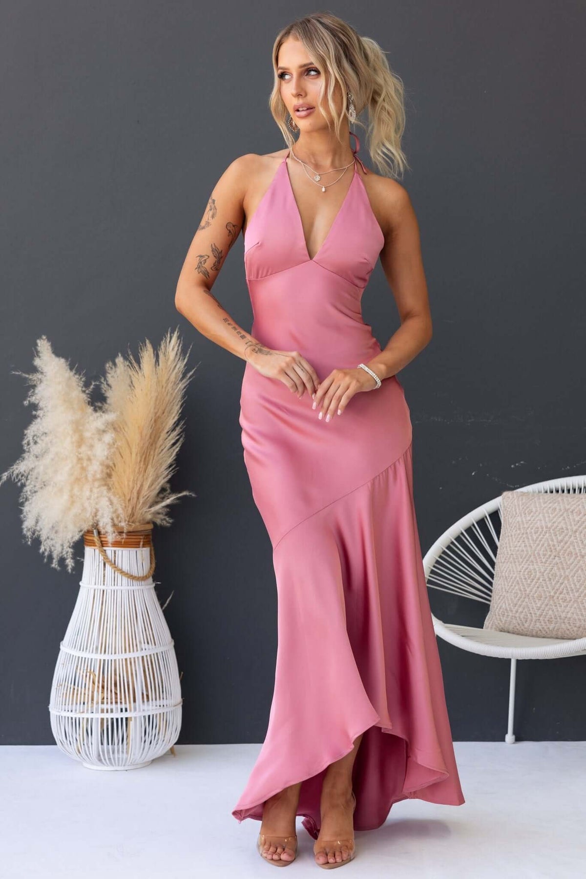 Elegant Ramona Maxi Dress in soft pink, featuring a tie neckline, fitted silhouette, and flowing hemline.