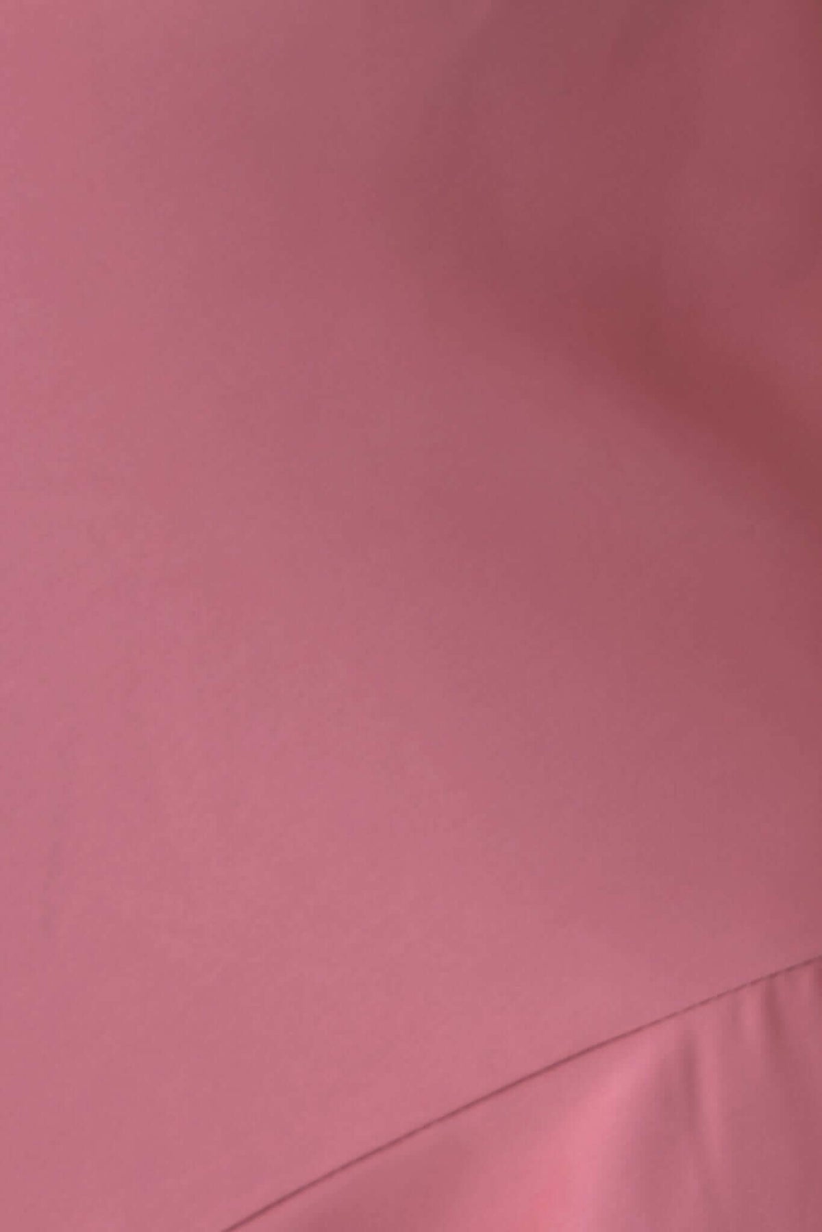 Close-up of soft pink fabric for Ramona Maxi Dress, showcasing its smooth texture and elegant color.