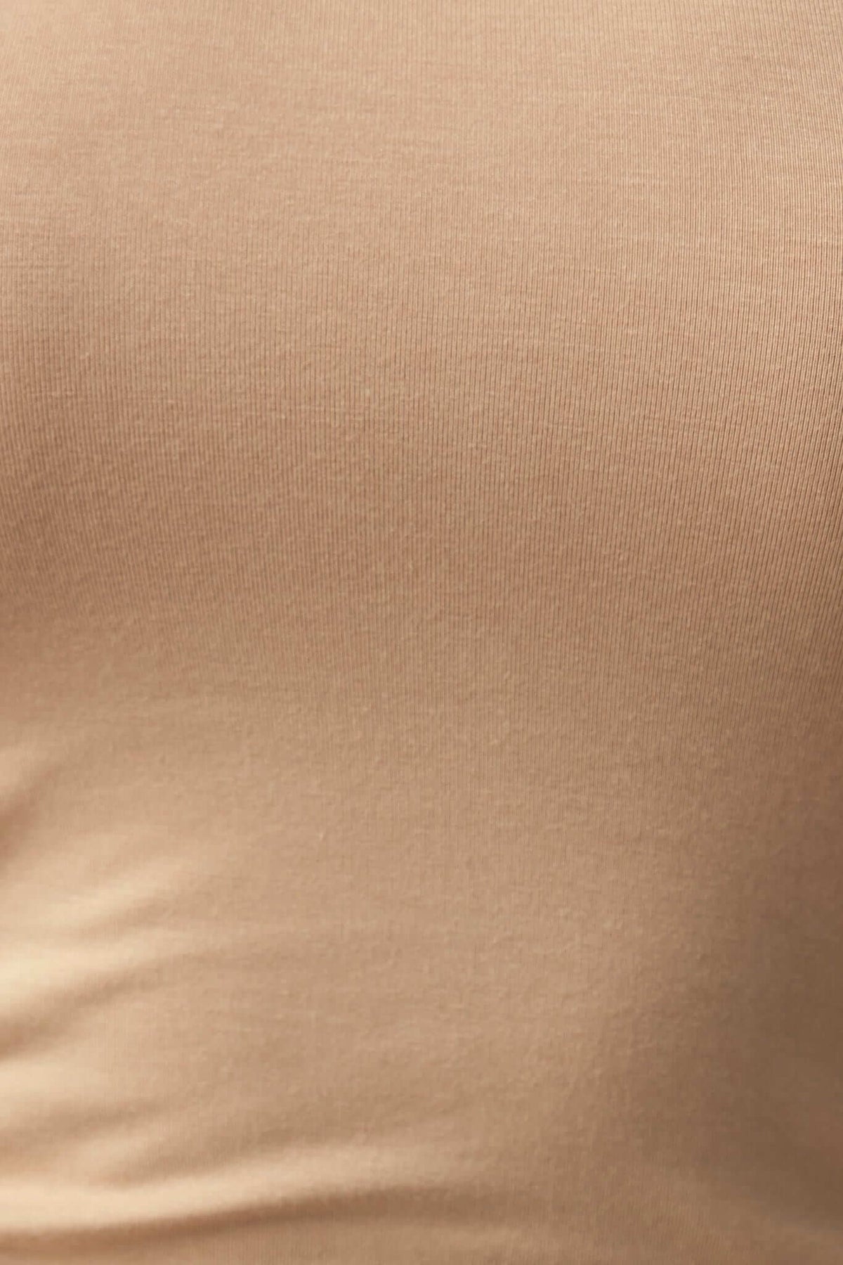 Close-up of soft, stretchy polyester fabric in a neutral beige color, ideal for comfortable bodycon dresses.