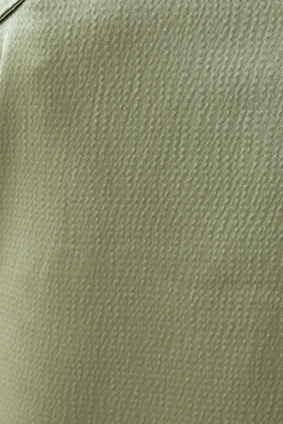 Close-up of lightly textured olive green fabric used in Hampton Style Pants, showcasing the material's unique finish.