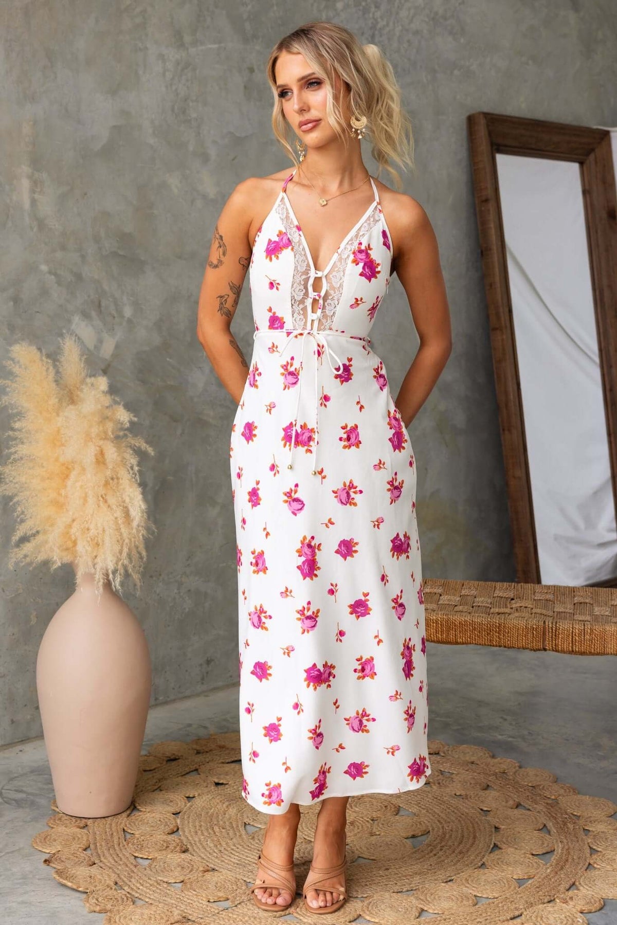 Floral print Paige midi dress with adjustable halter neckline and side zipper, styled with vintage decor.