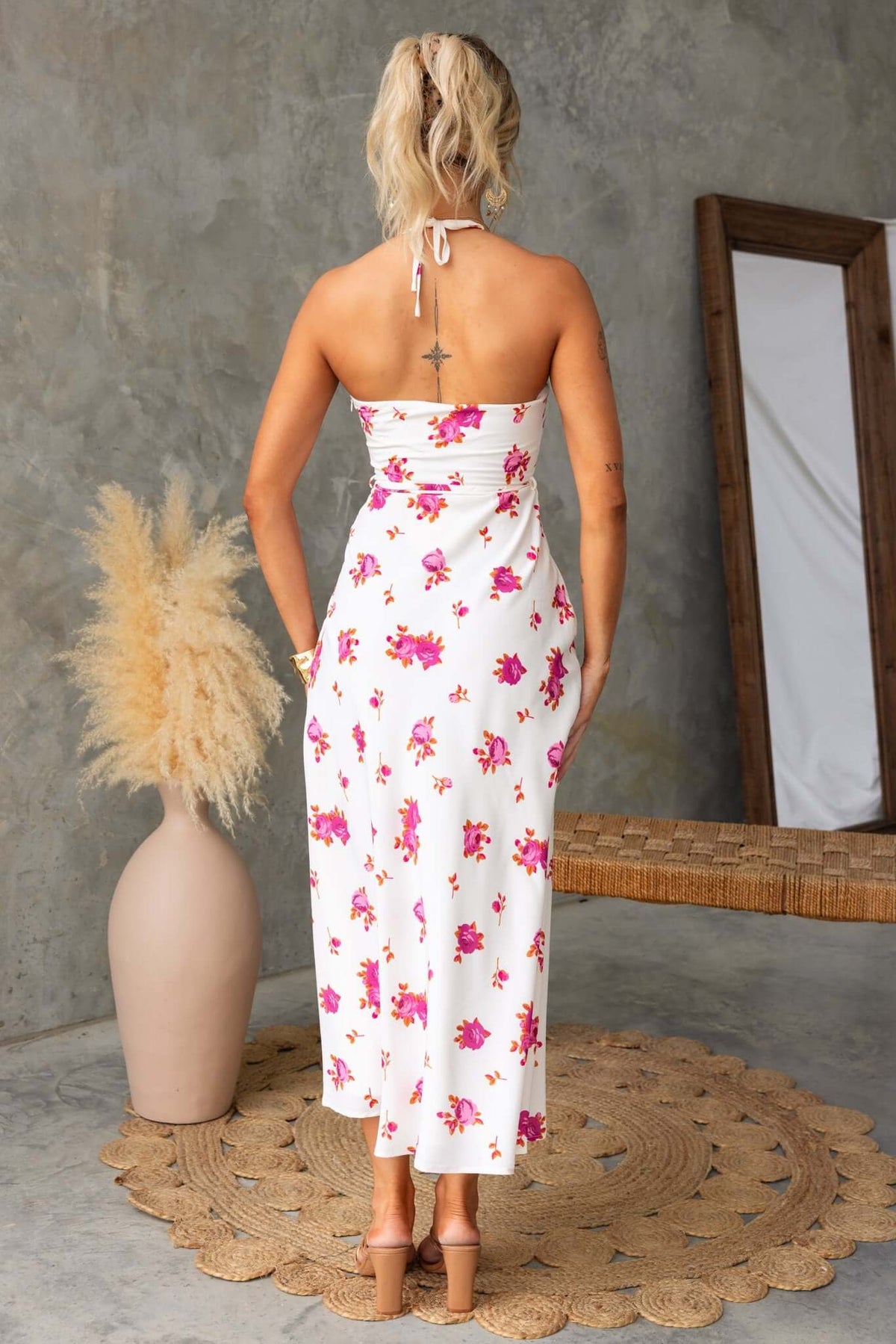 Back view of Paige floral print midi dress featuring adjustable tie halter neckline and lined design.