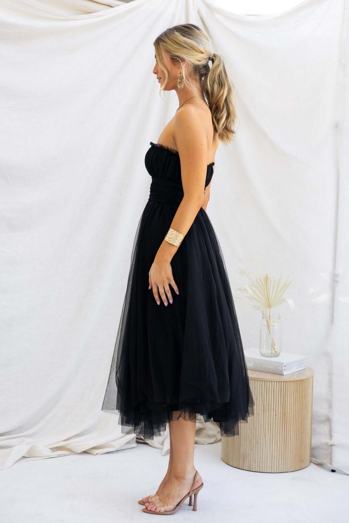 Model wearing Sweetest Treat Maxi Dress with black tulle overlay, strapless design, and anti-slip bust features.