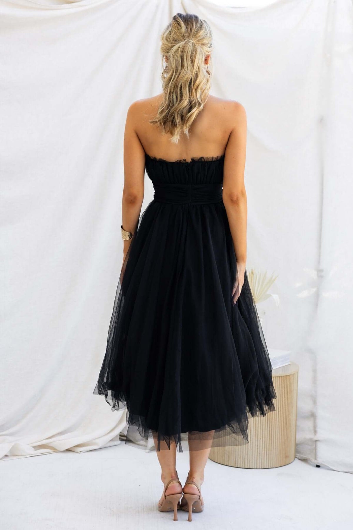 Back view of the black Sweetest Treat Maxi Dress, featuring tulle overlay and strapless design.