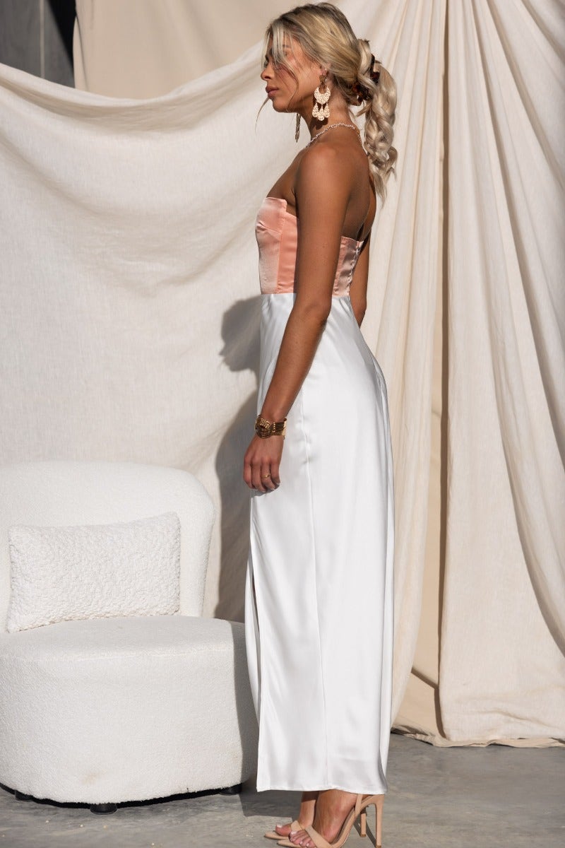 Model wearing Katya Maxi Dress in satin, featuring strapless design, split front, and lined interior, perfect for elegant occasions.
