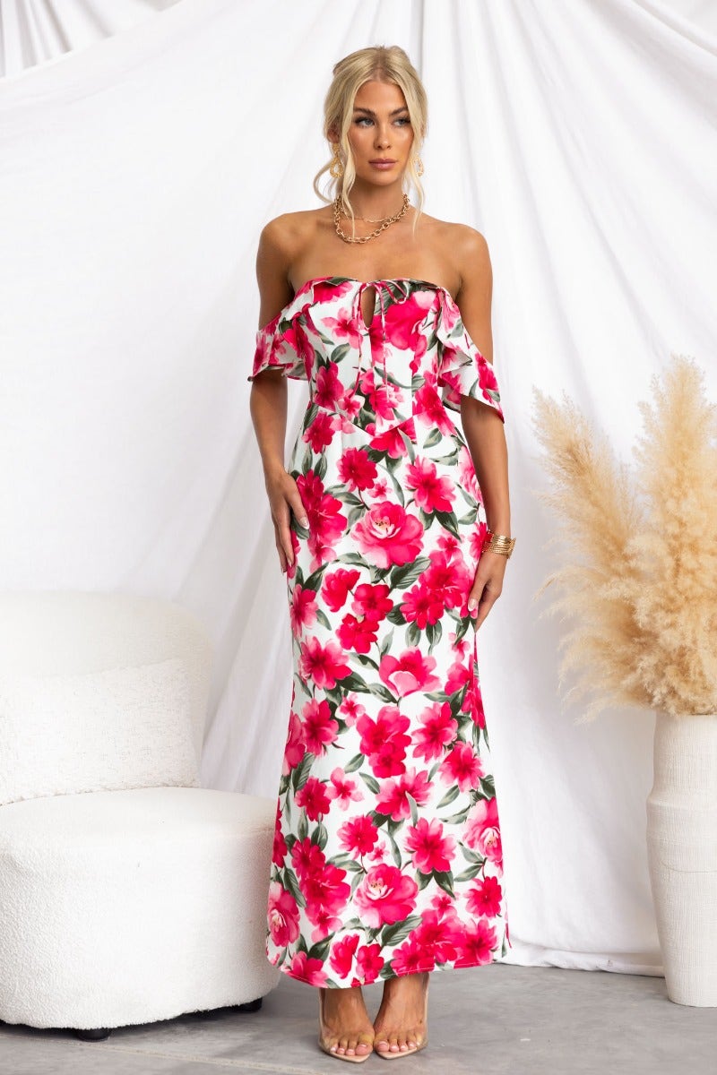 Model wearing Take A Breath maxi dress with floral print and off-shoulder neckline, styled for summer fashion.