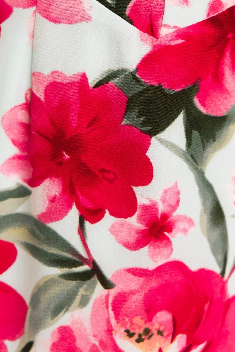 Floral print detail of the Take A Breath Maxi Dress featuring vibrant pink flowers on a soft background.