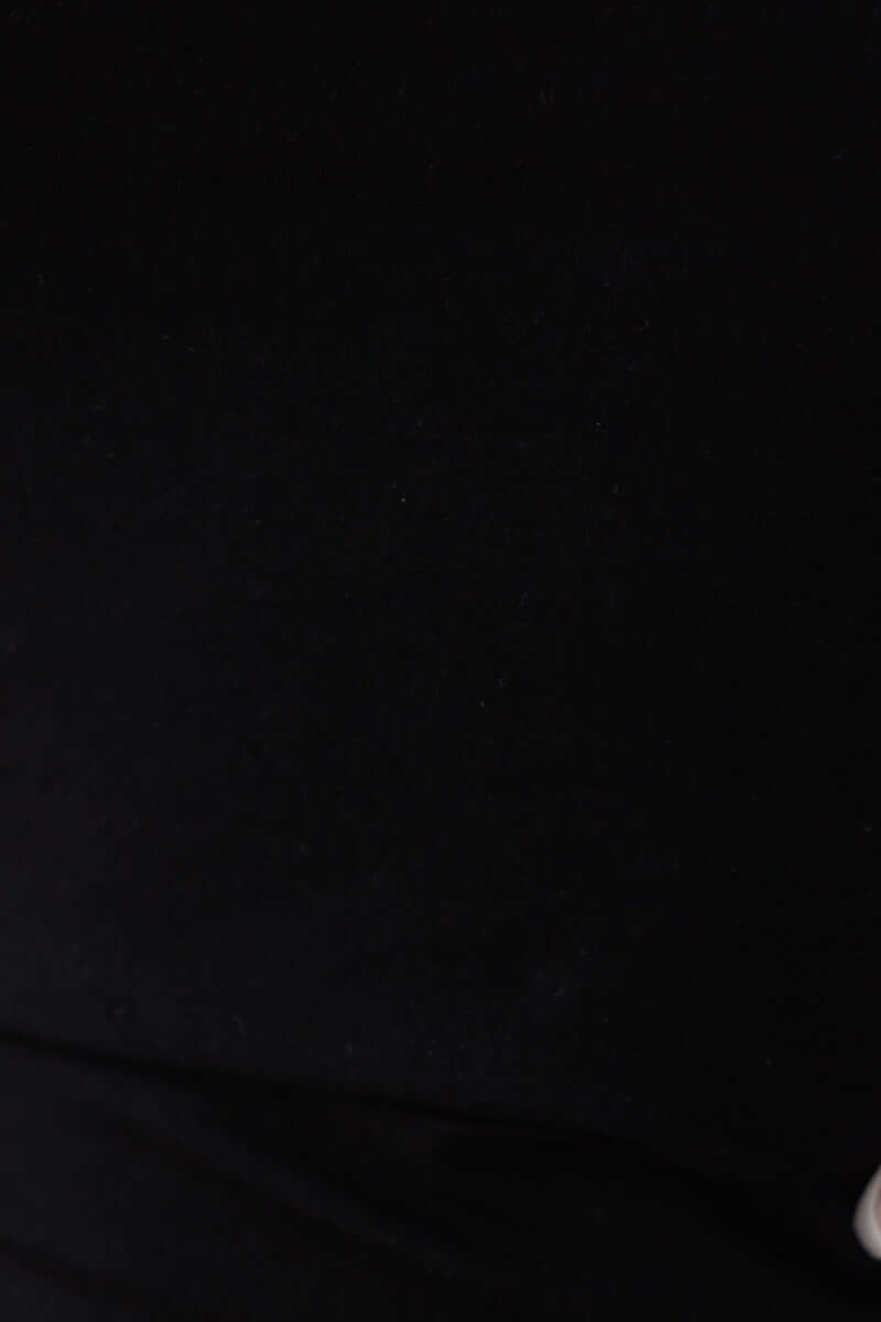 Close-up of black fabric showcasing the stretch material of the Lois Midi Dress, ideal for a bodycon fit.