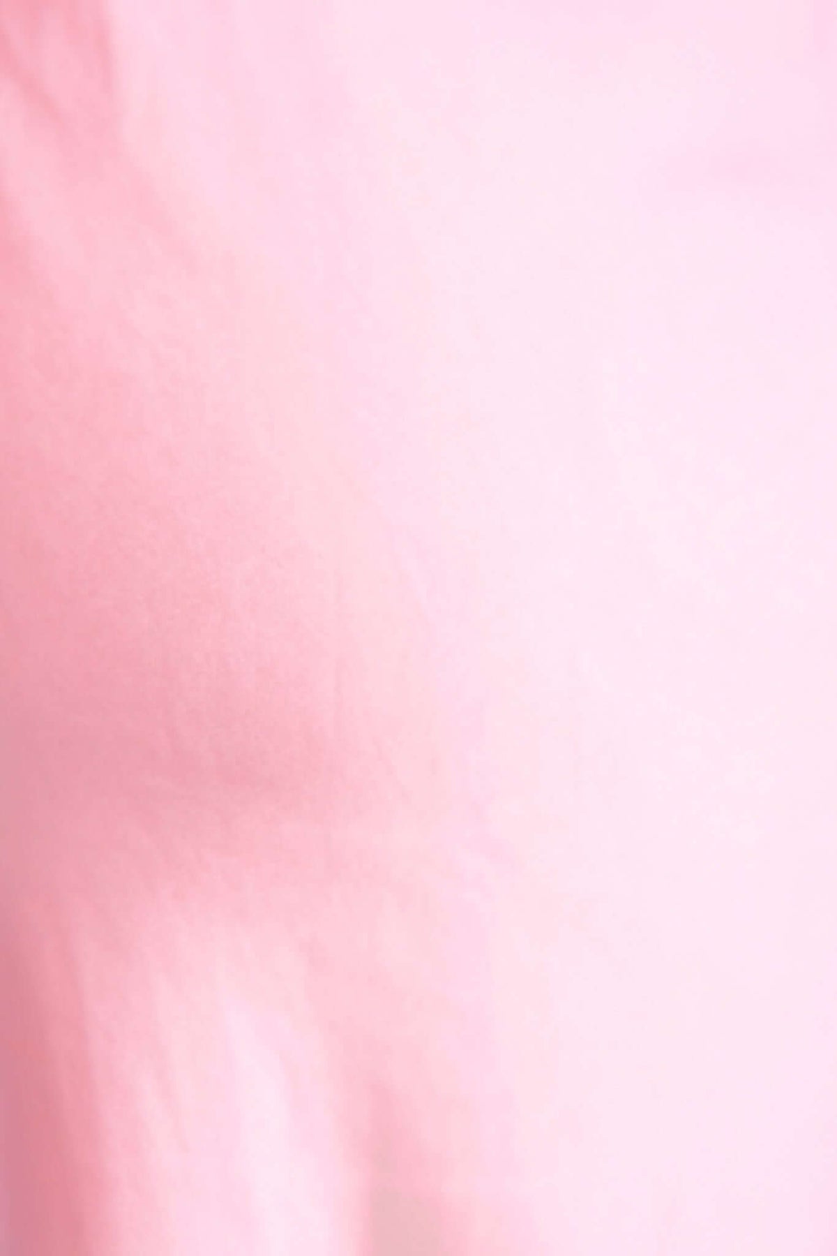 Close-up of soft pink fabric texture, showcasing smooth and lightweight material perfect for summer apparel.