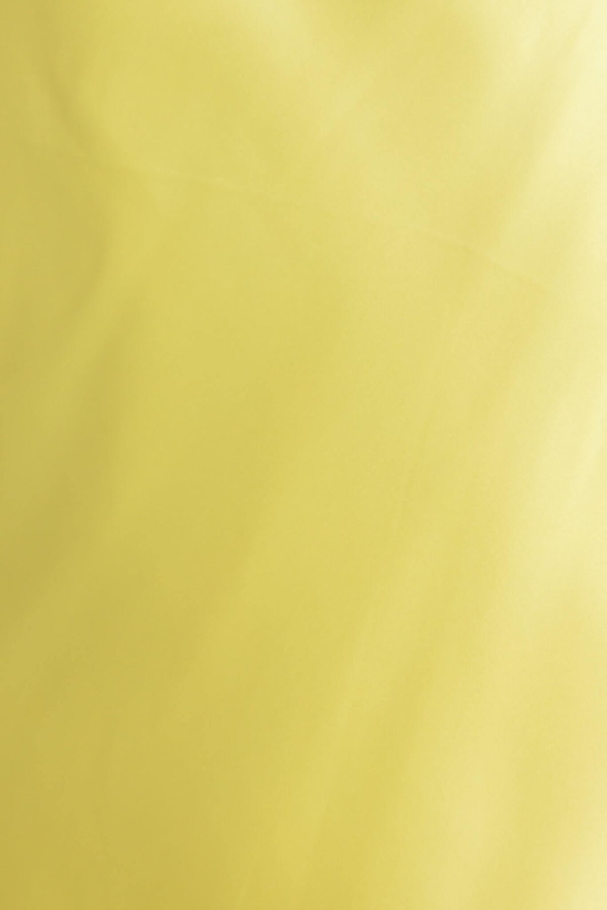 Close-up of soft yellow satin fabric, ideal for elegant garments like the Tulip Maxi Dress.