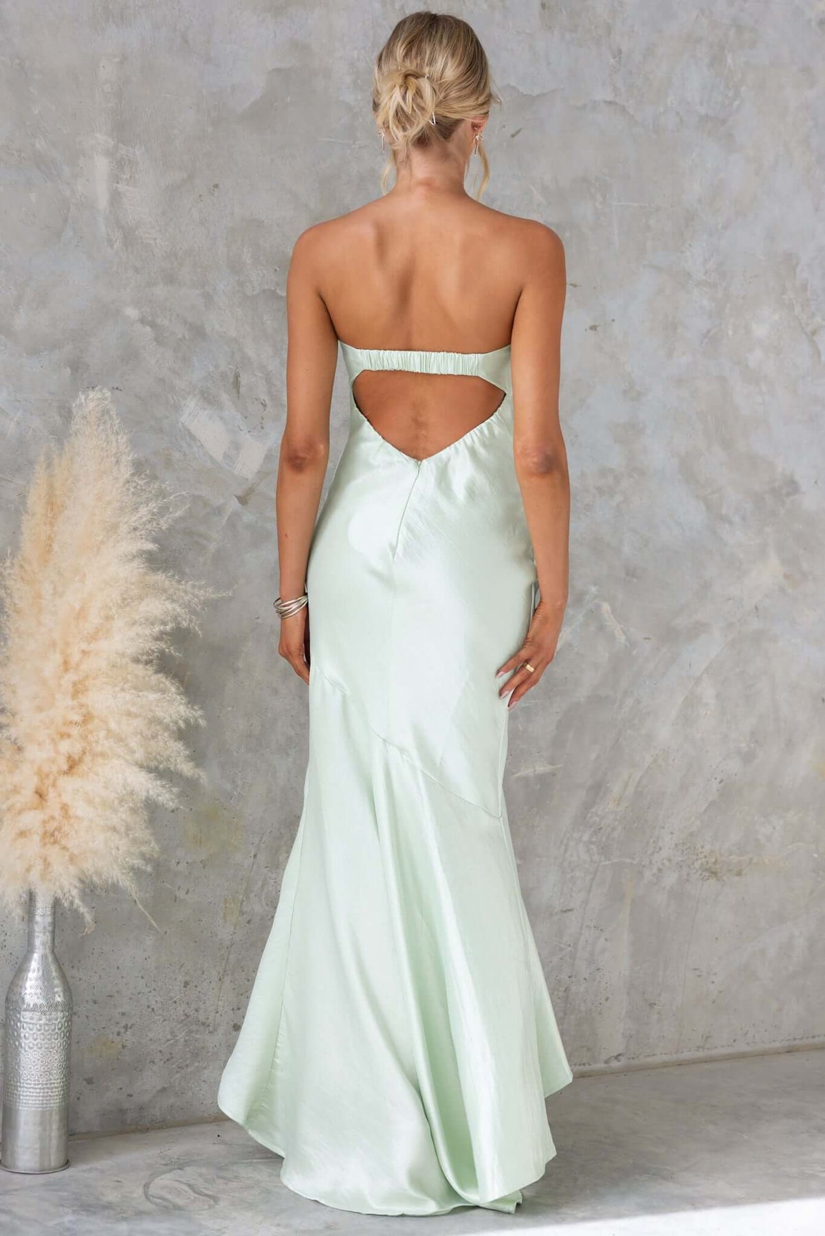 Back view of Sancia Maxi Dress in mint green, featuring strapless design and elegant cutout detail.