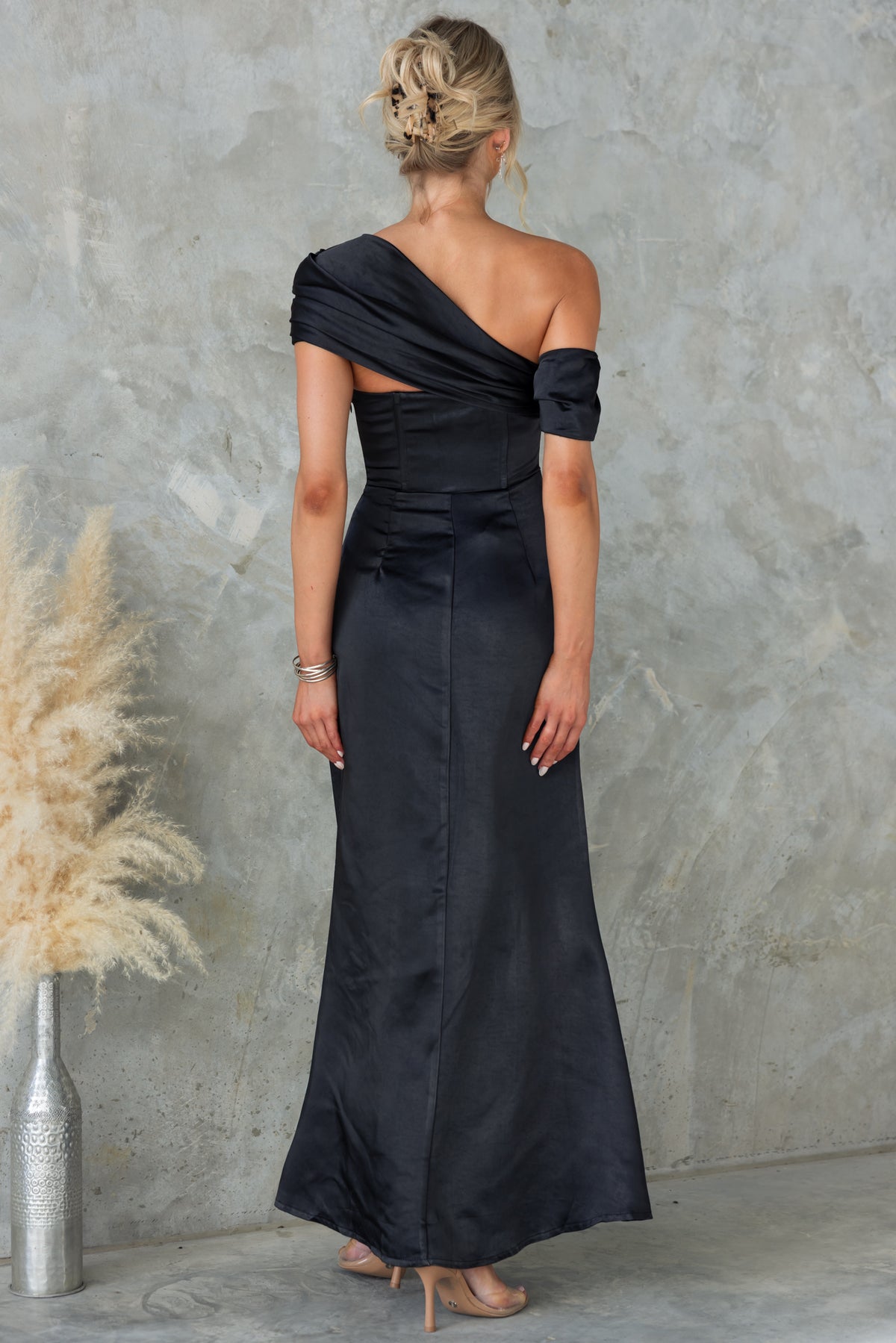 Back view of Sonnet Maxi Dress featuring asymmetric neckline and satin fabric, perfect for special occasions.